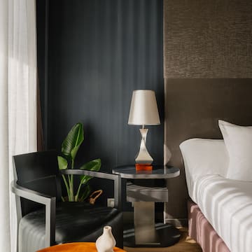 a room with a bed and a lamp