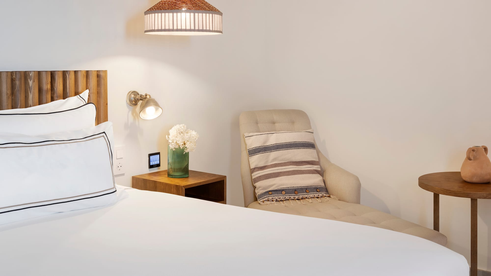 a bed with a chair and a lamp