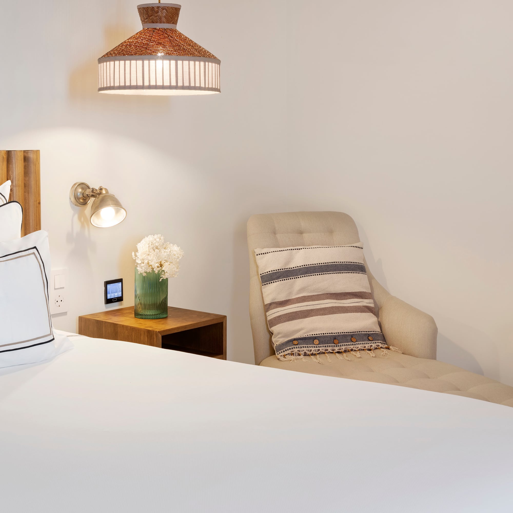 a bed with a chair and a lamp