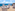 Outdoor terrace with white cocktail tables, snacks, and ocean view.
