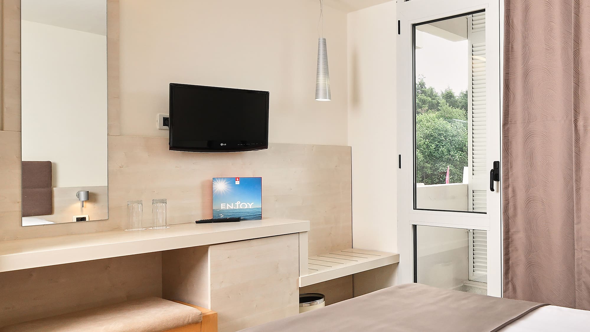 a bedroom with a bed and a television