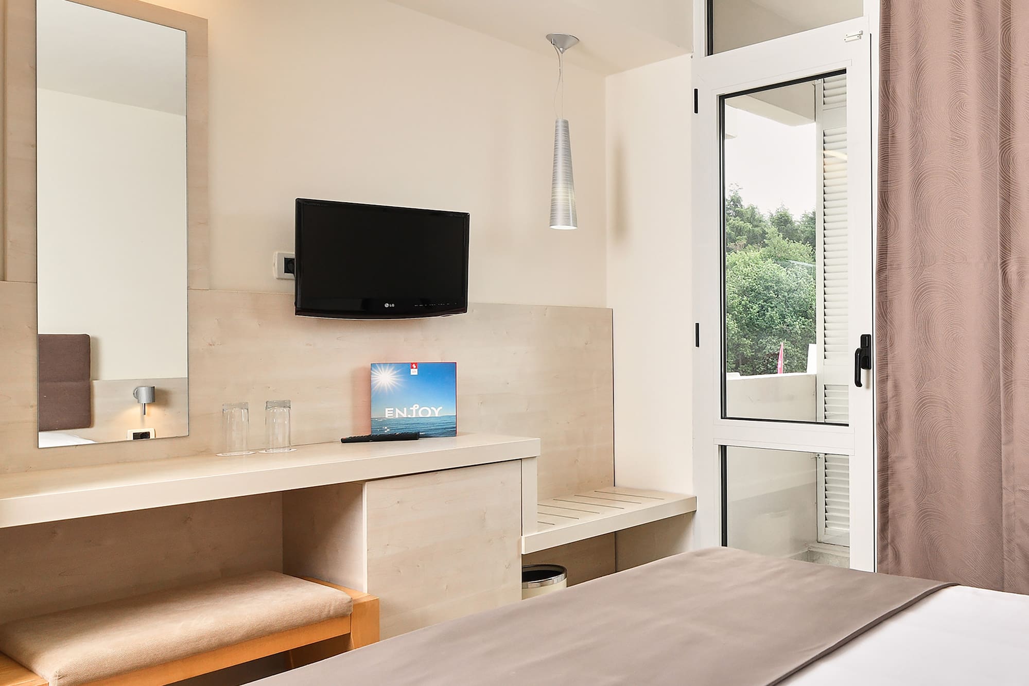 a bedroom with a bed and a television