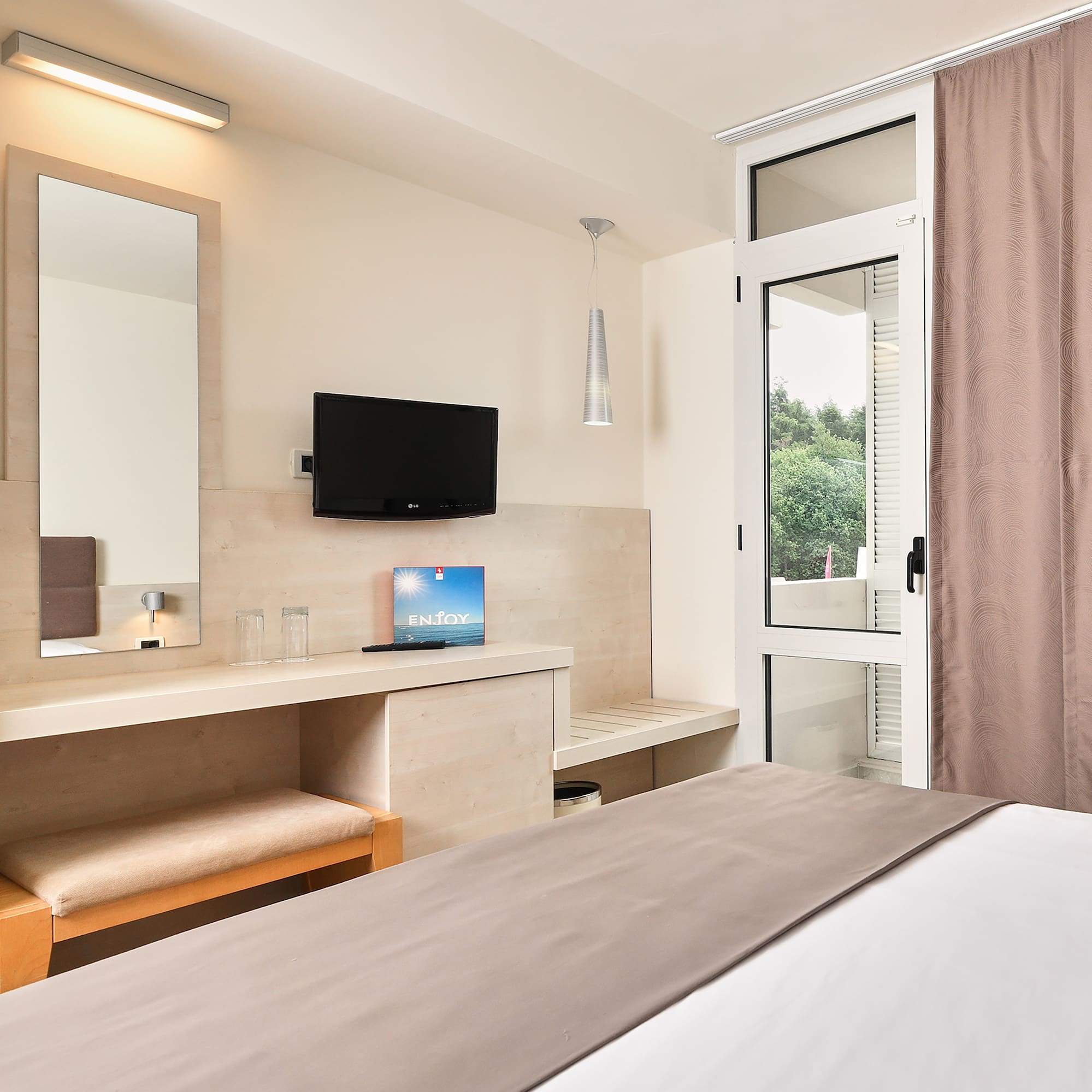 a bedroom with a bed and a television