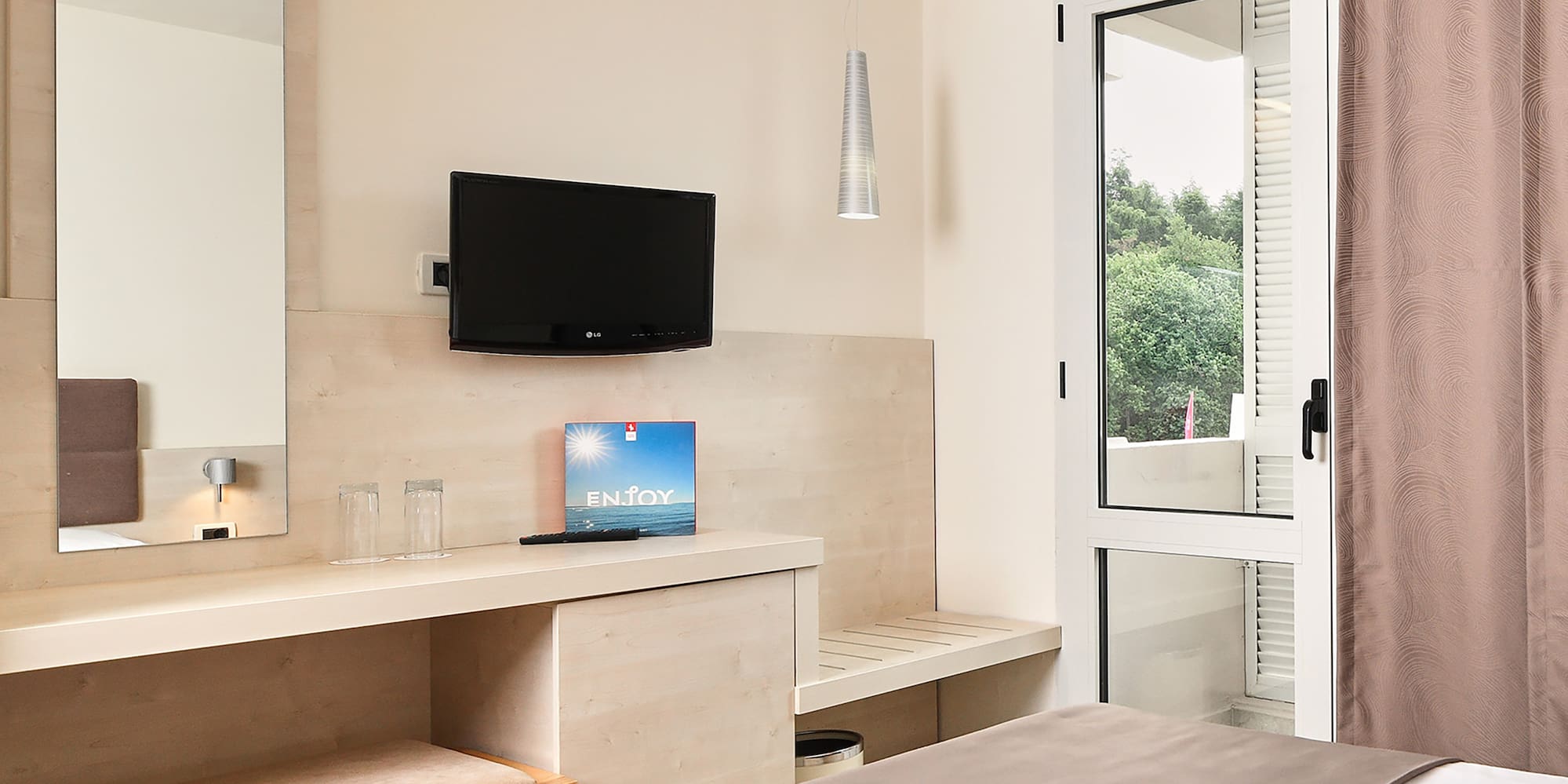 a bedroom with a bed and a television