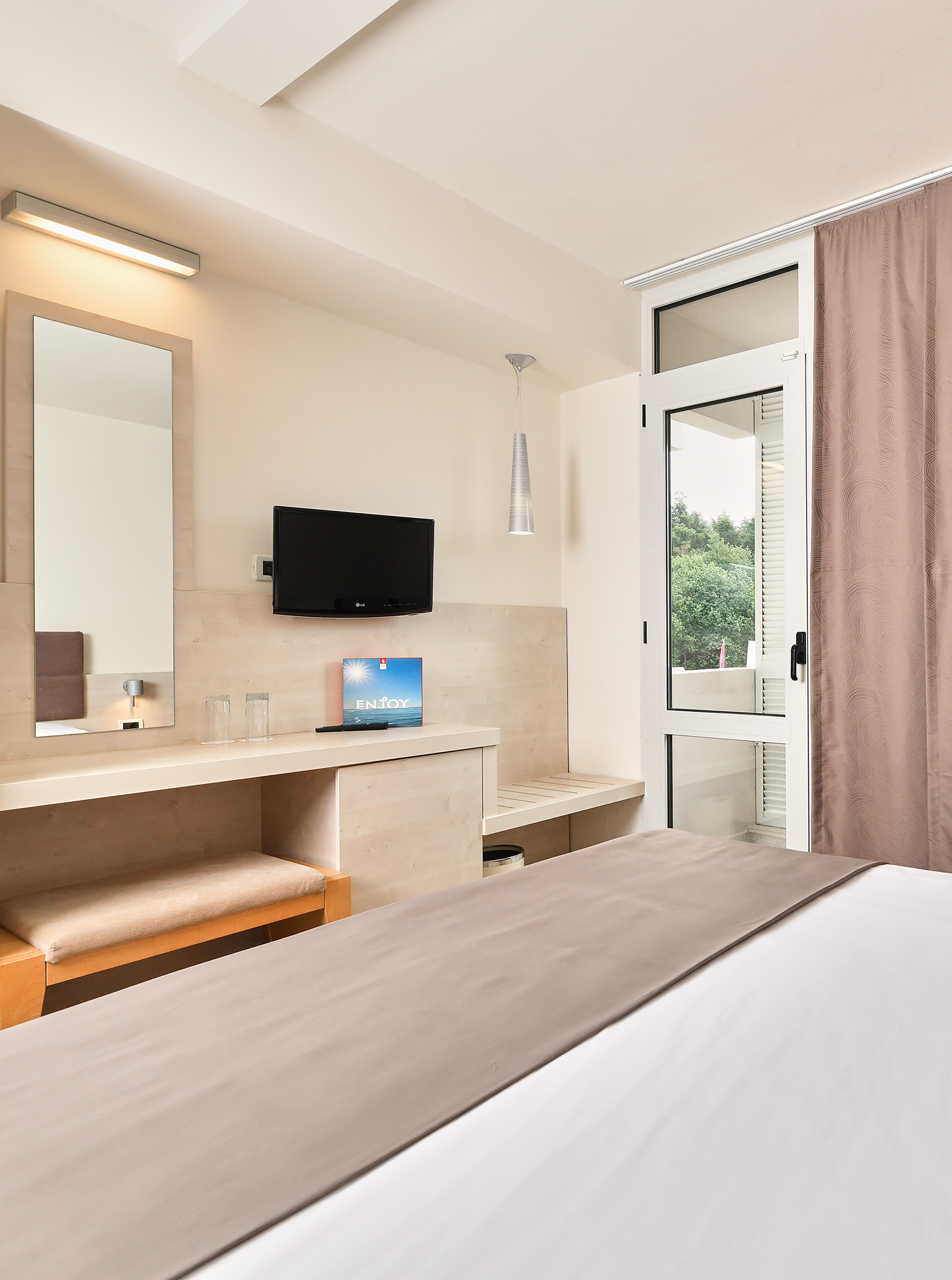 a bedroom with a bed and a television