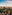 Alhambra palace and fortress, Granada, Spain, at sunset with mountains.