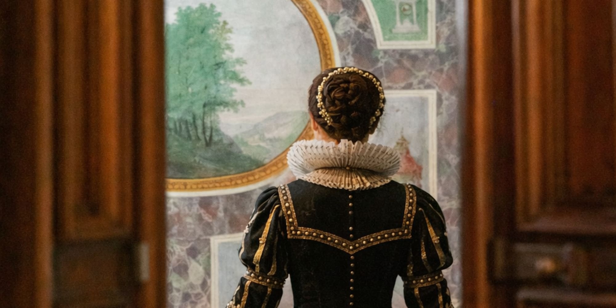 Woman in historical black gown with ruff collar looking at renaissance fresco.
