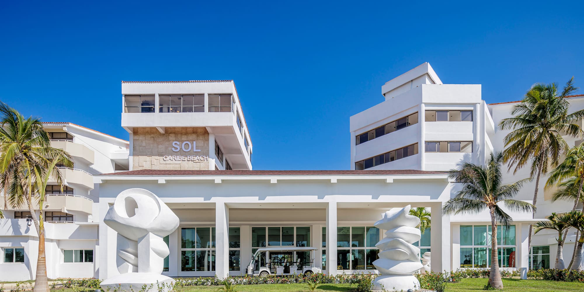 a white building with a large white sculpture in front of it
