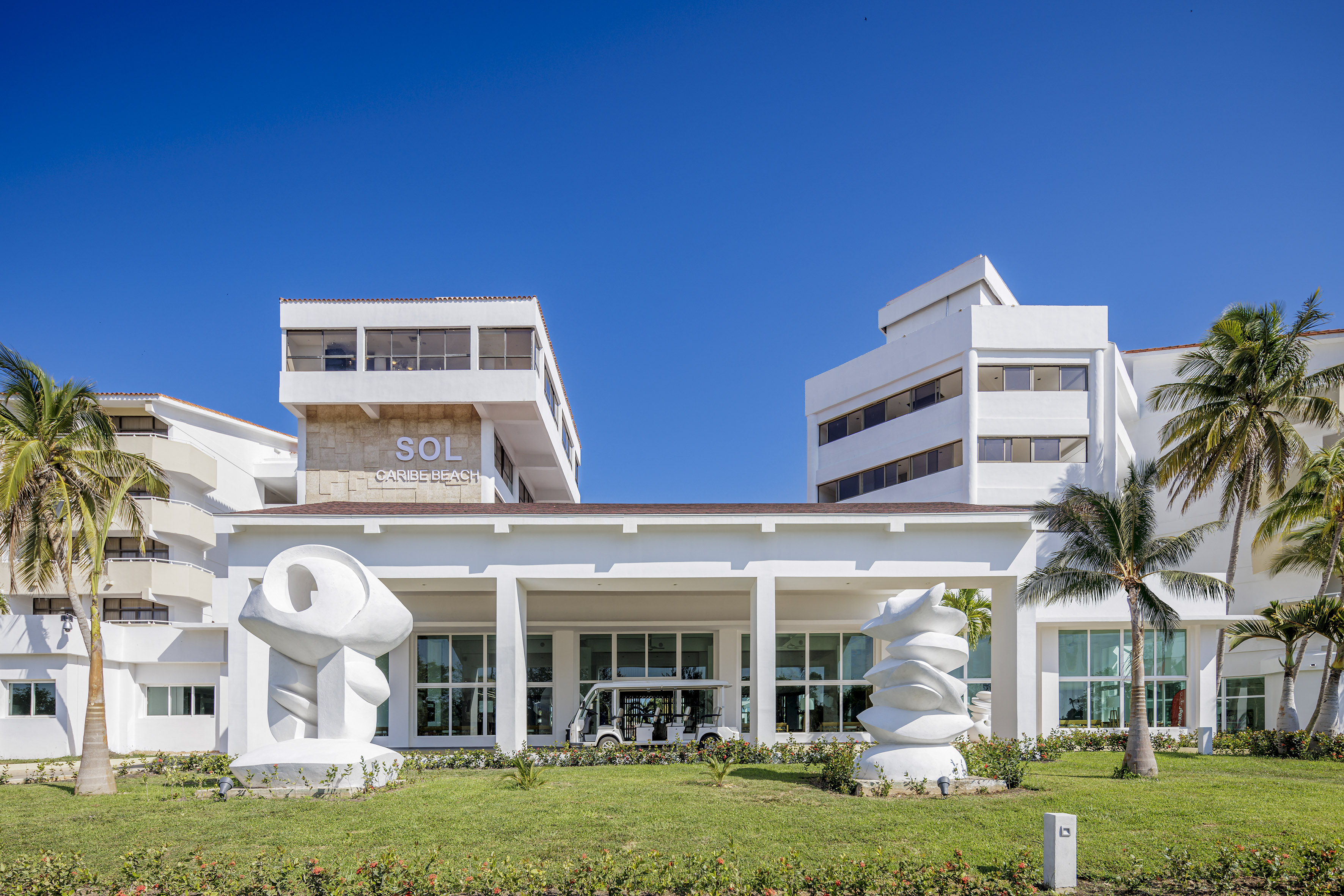 a white building with a large white sculpture in front of it