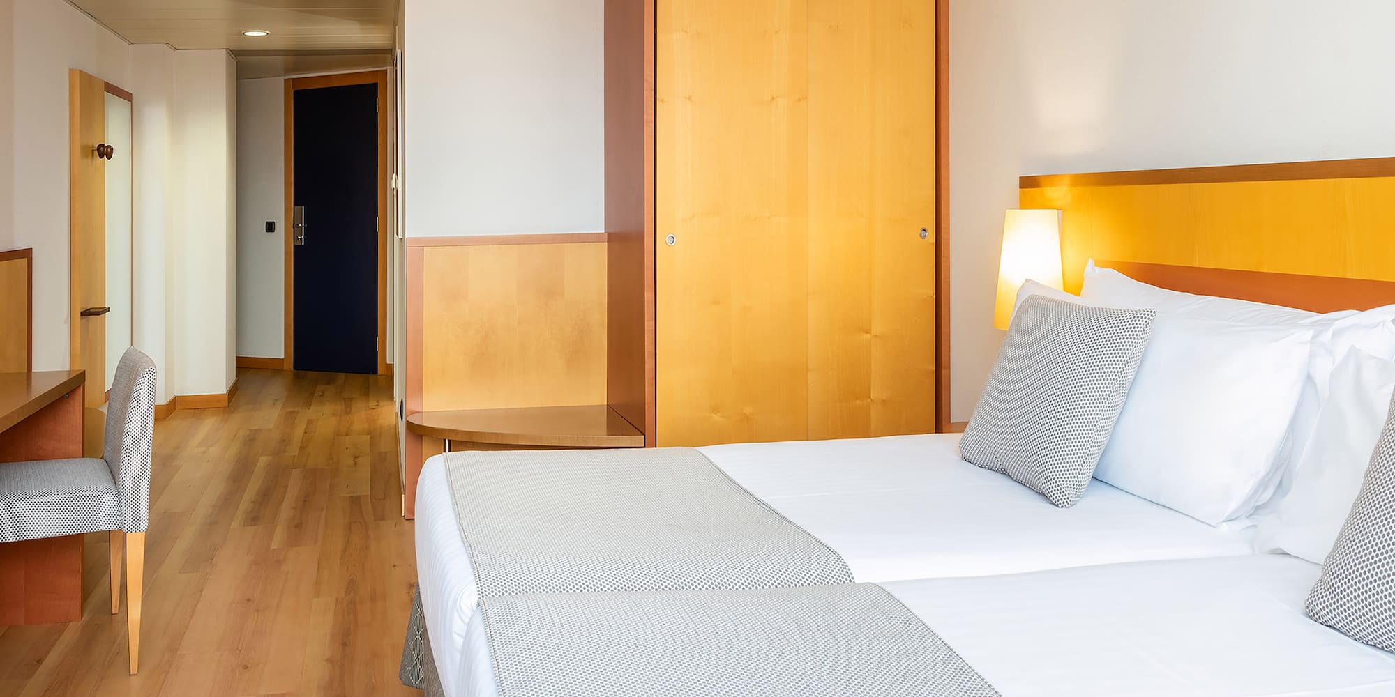 a room with two beds and a door