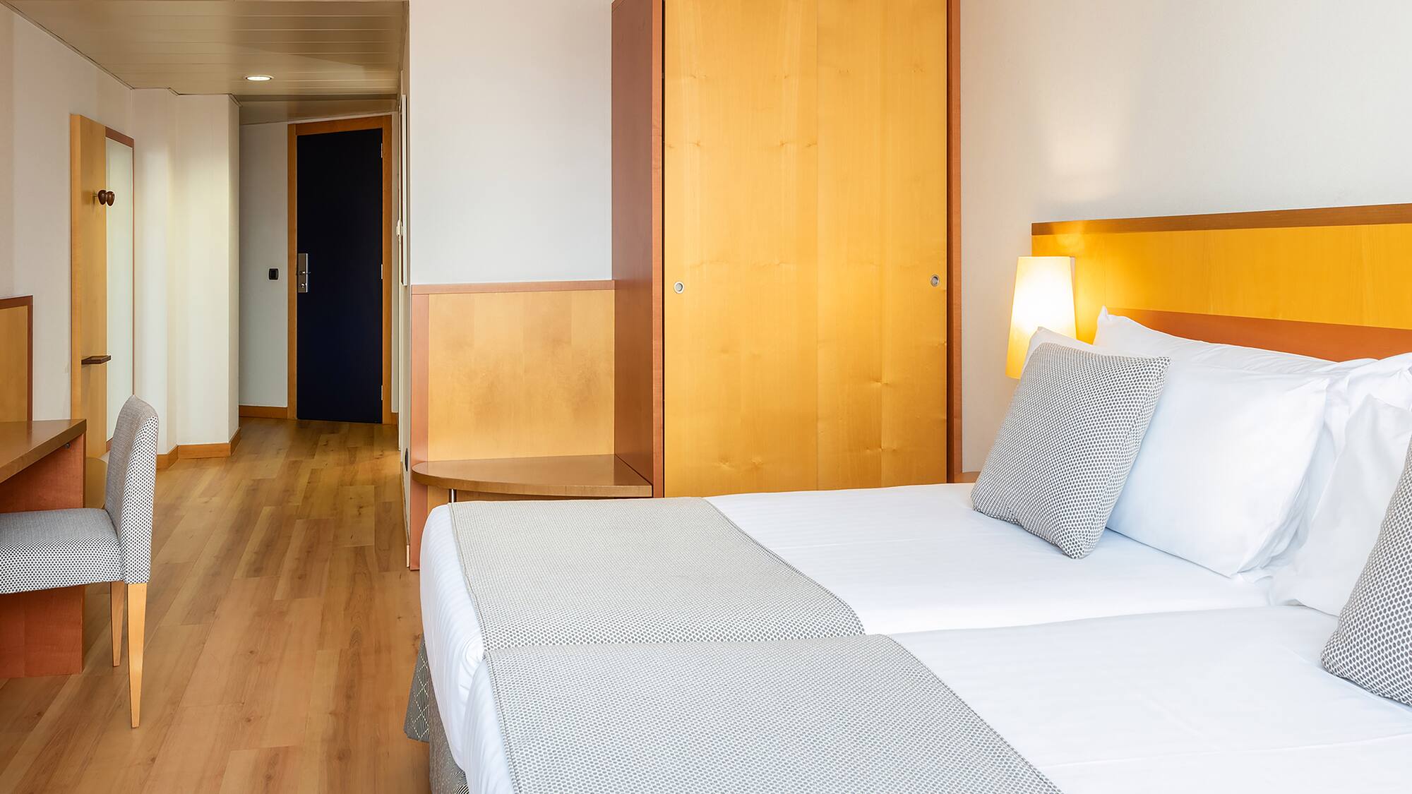 a room with two beds and a door