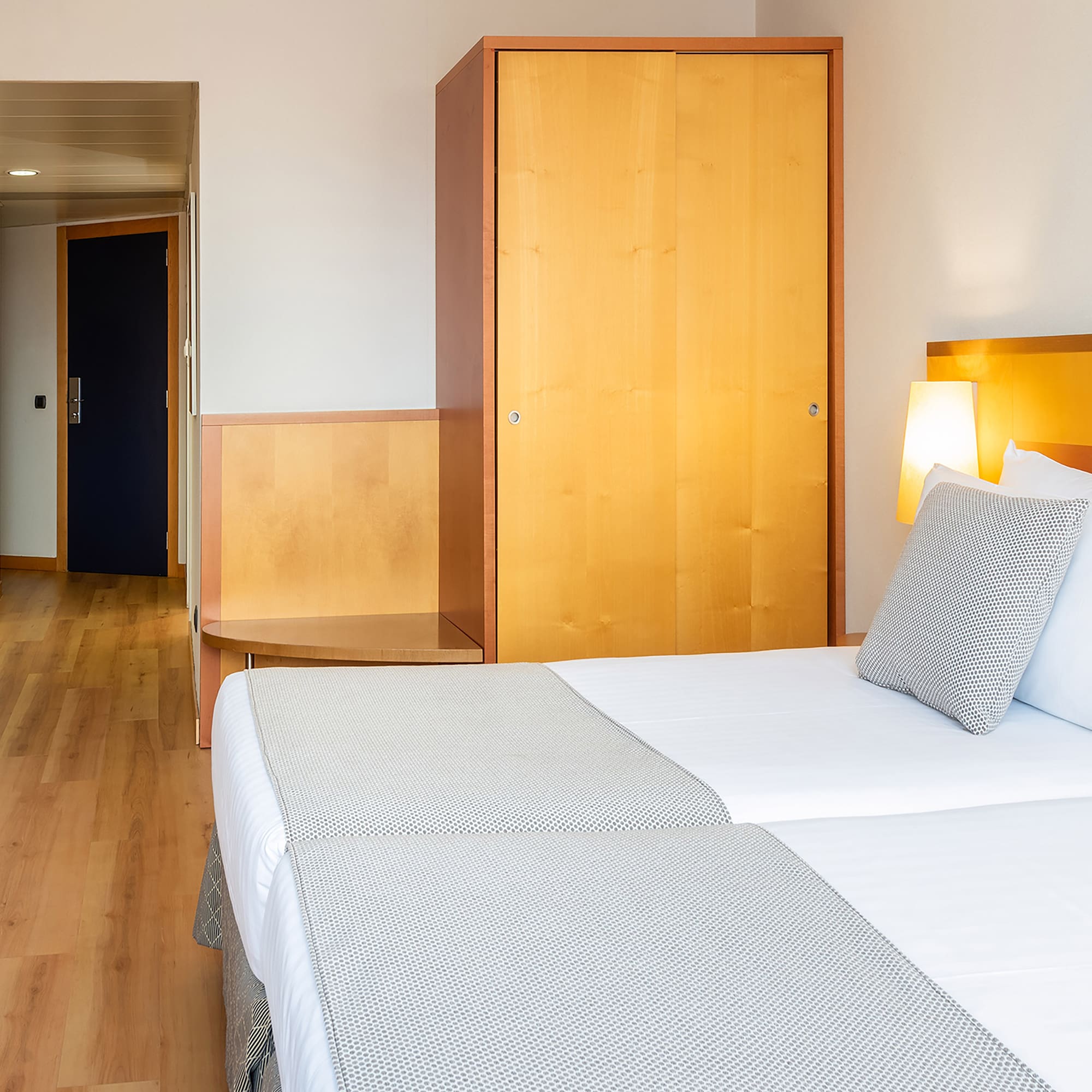 a room with two beds and a door