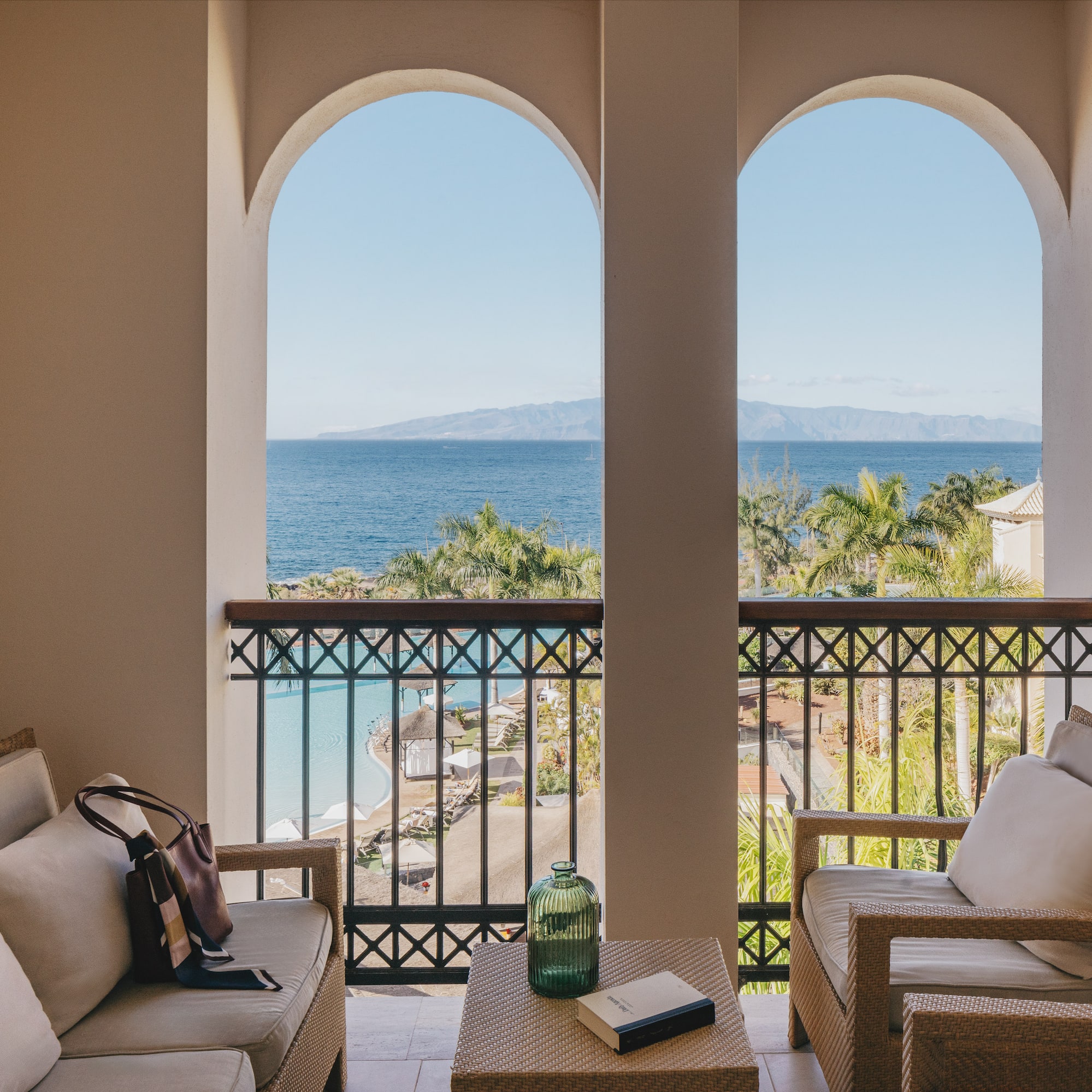 a balcony with a view of the ocean and a beach