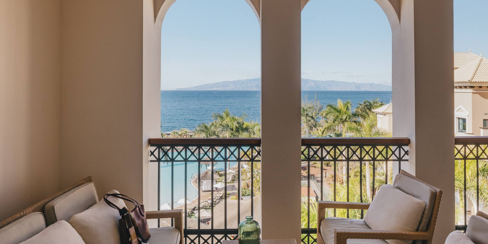 a balcony with a view of the ocean and a beach