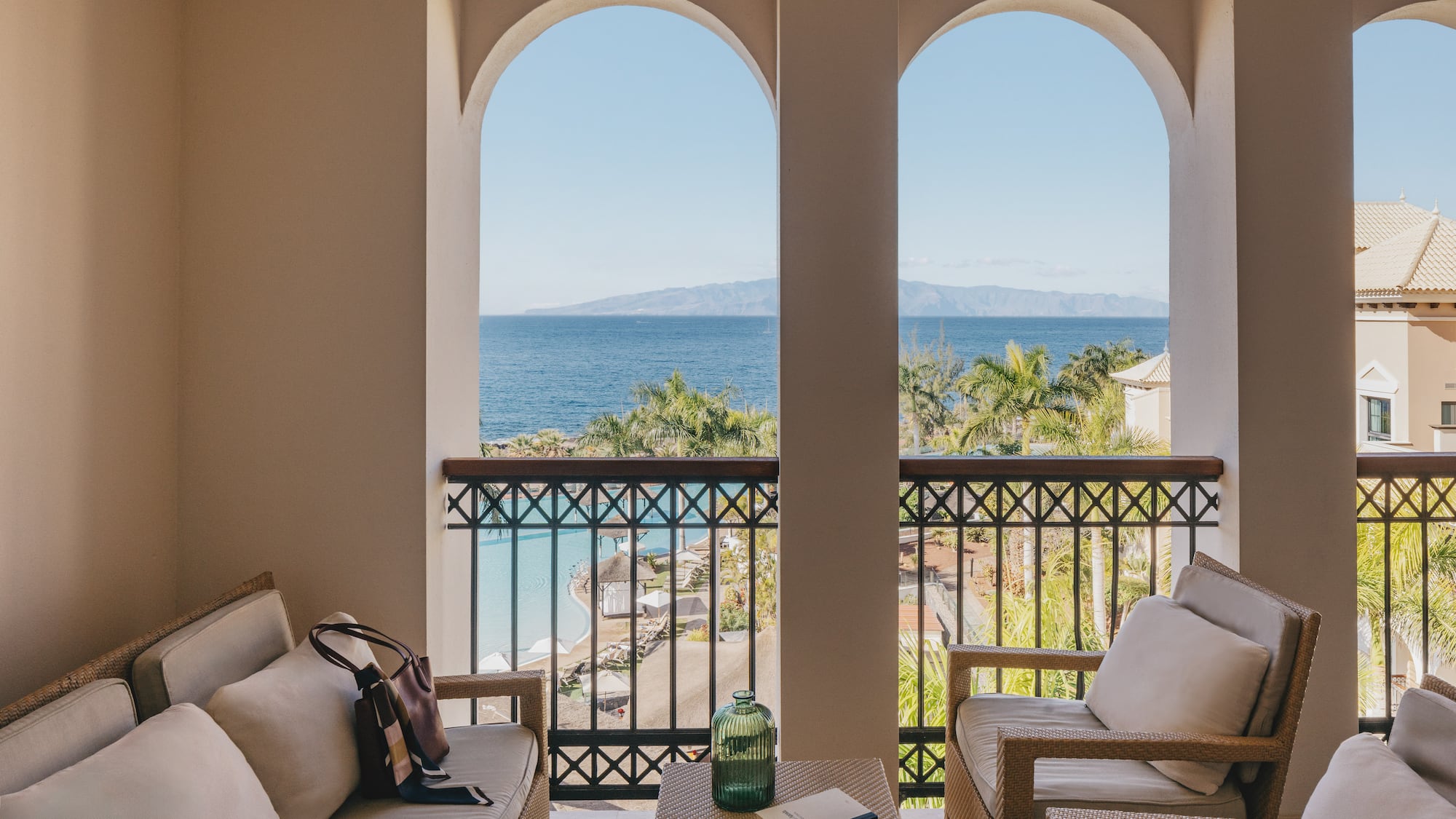 a balcony with a view of the ocean and a beach