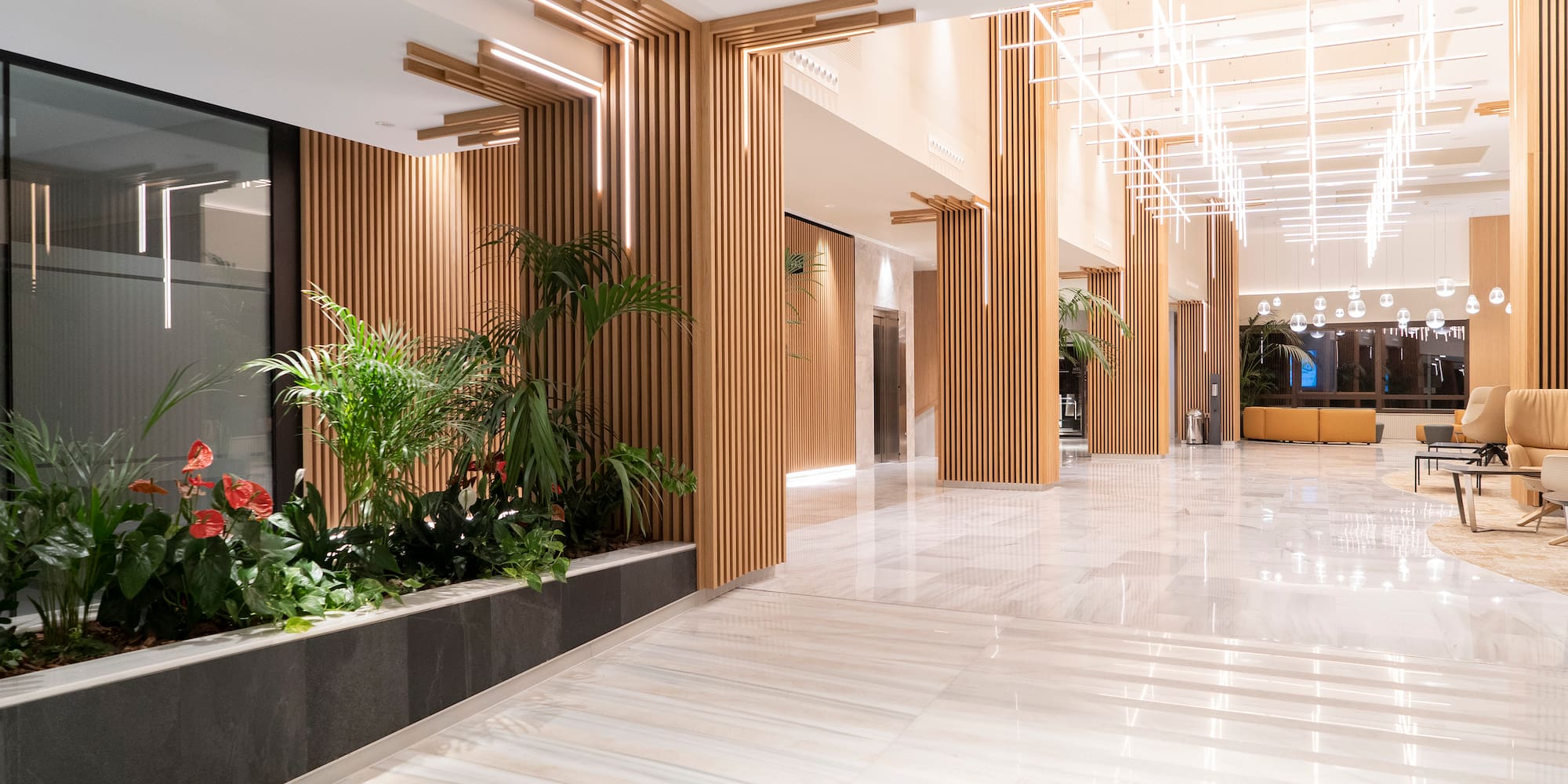 a large lobby with plants and a planter