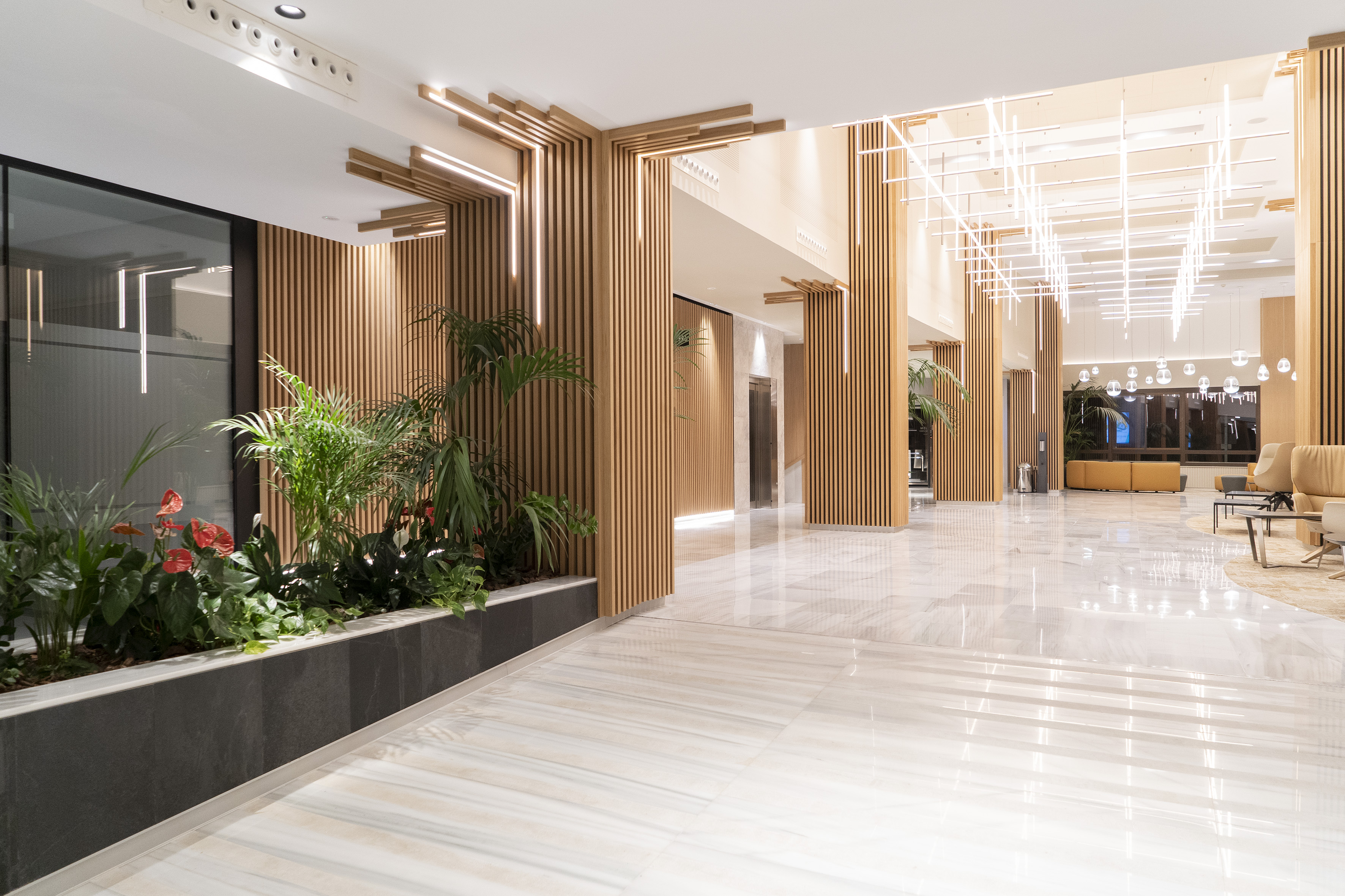 a large lobby with plants and a planter