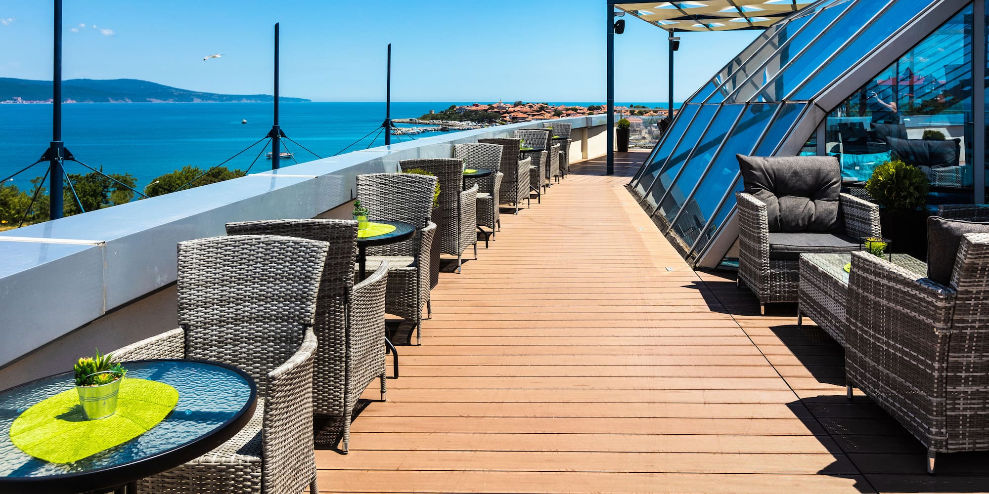 a deck with chairs and tables on a sunny day