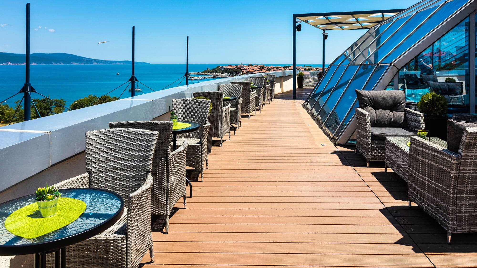 a deck with chairs and tables on a sunny day