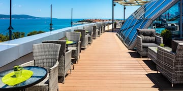 a deck with chairs and tables on a sunny day