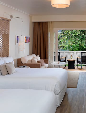 a room with two beds and a patio