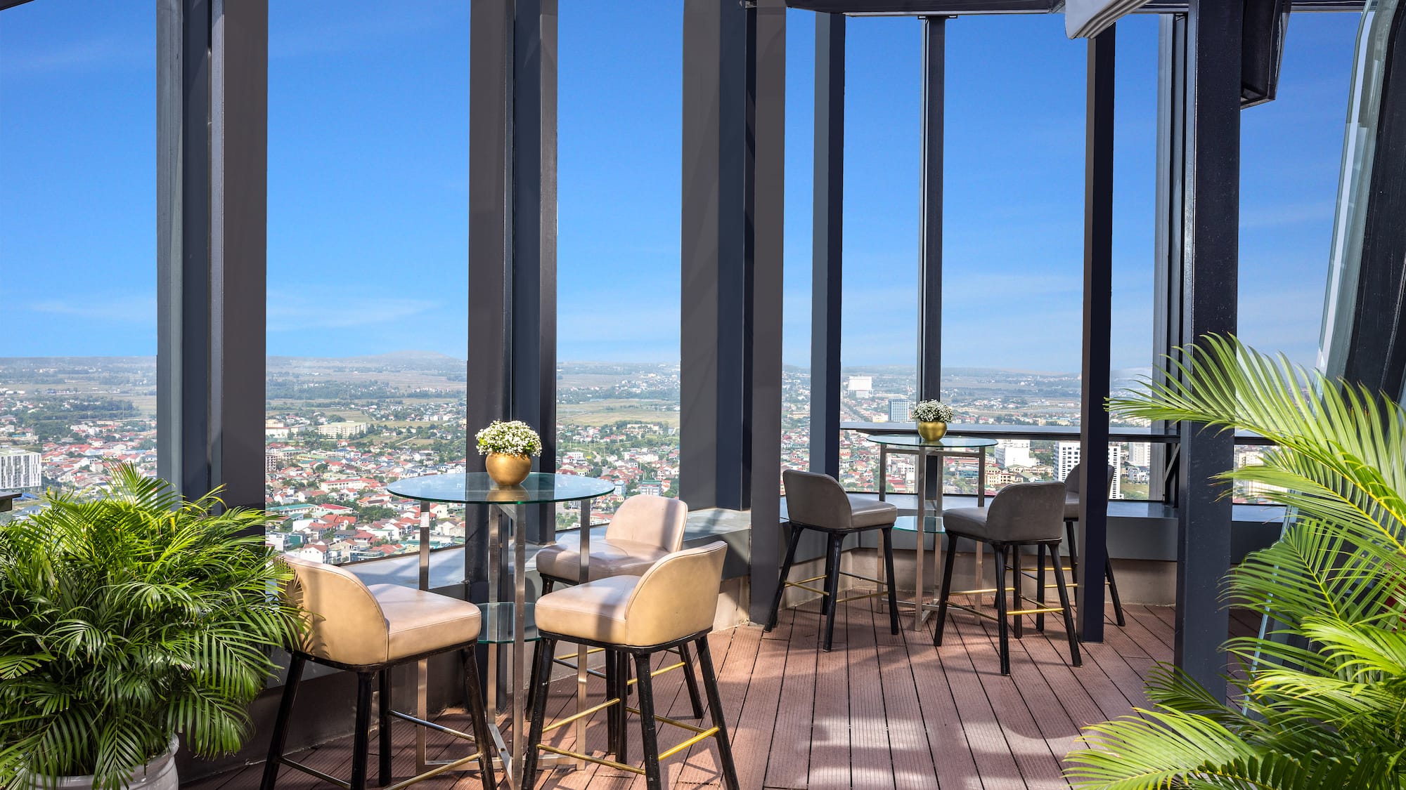 a patio with tables and chairs and a view of a city