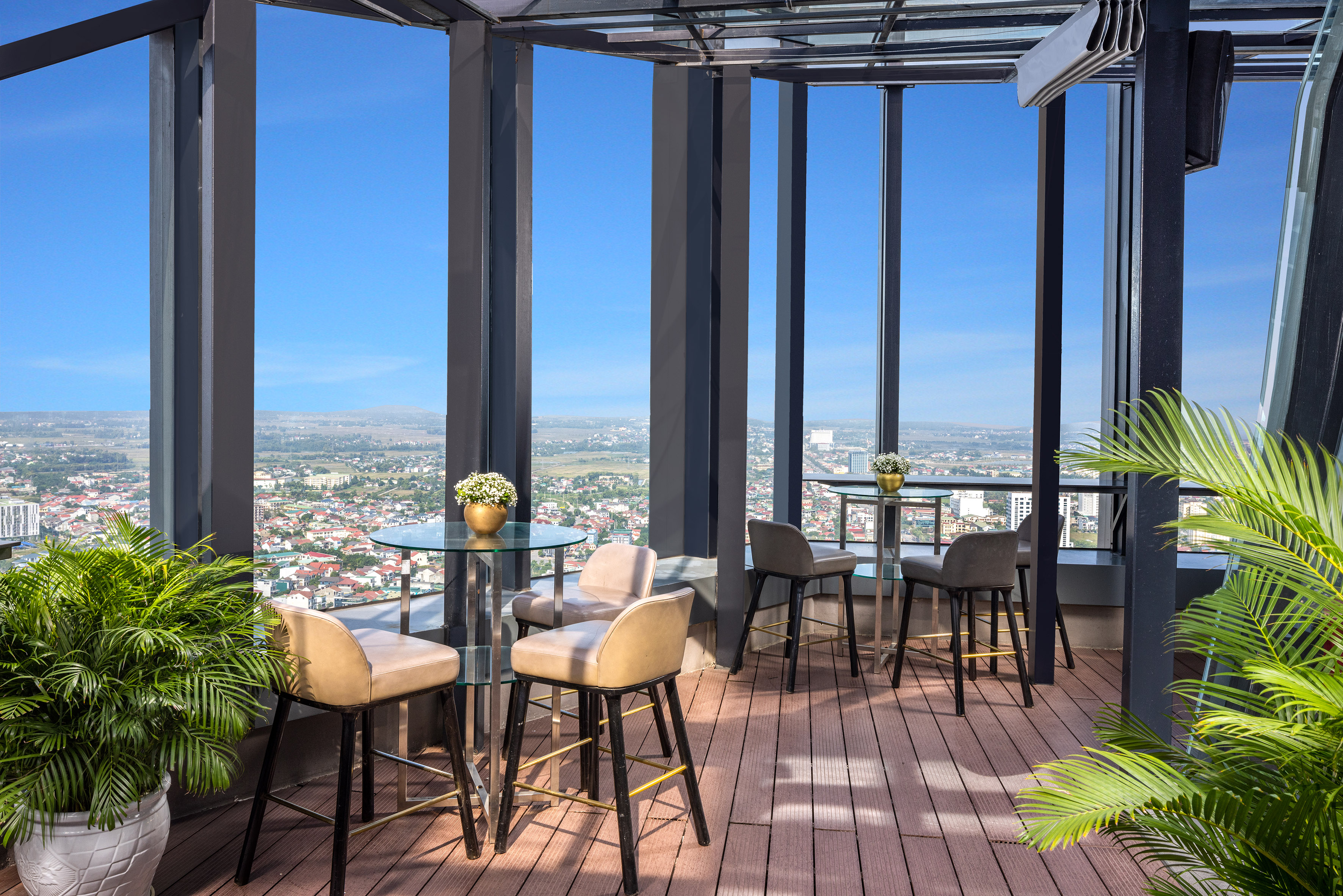 a patio with tables and chairs and a view of a city