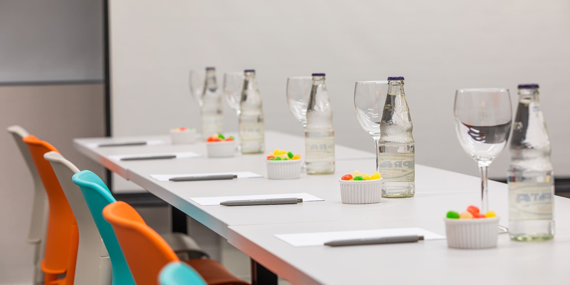 a table with glasses and water bottles on it