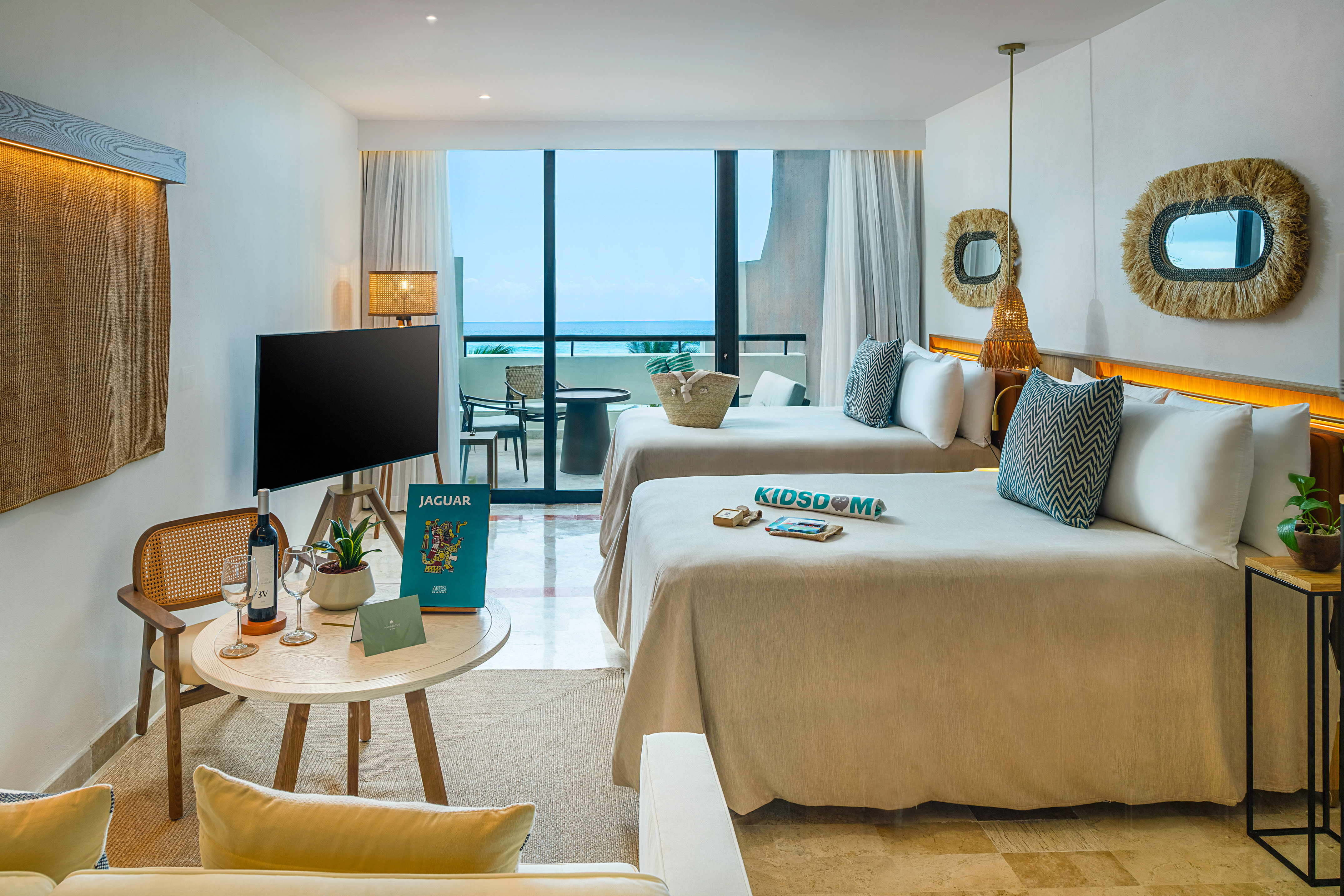 a room with two beds and a television