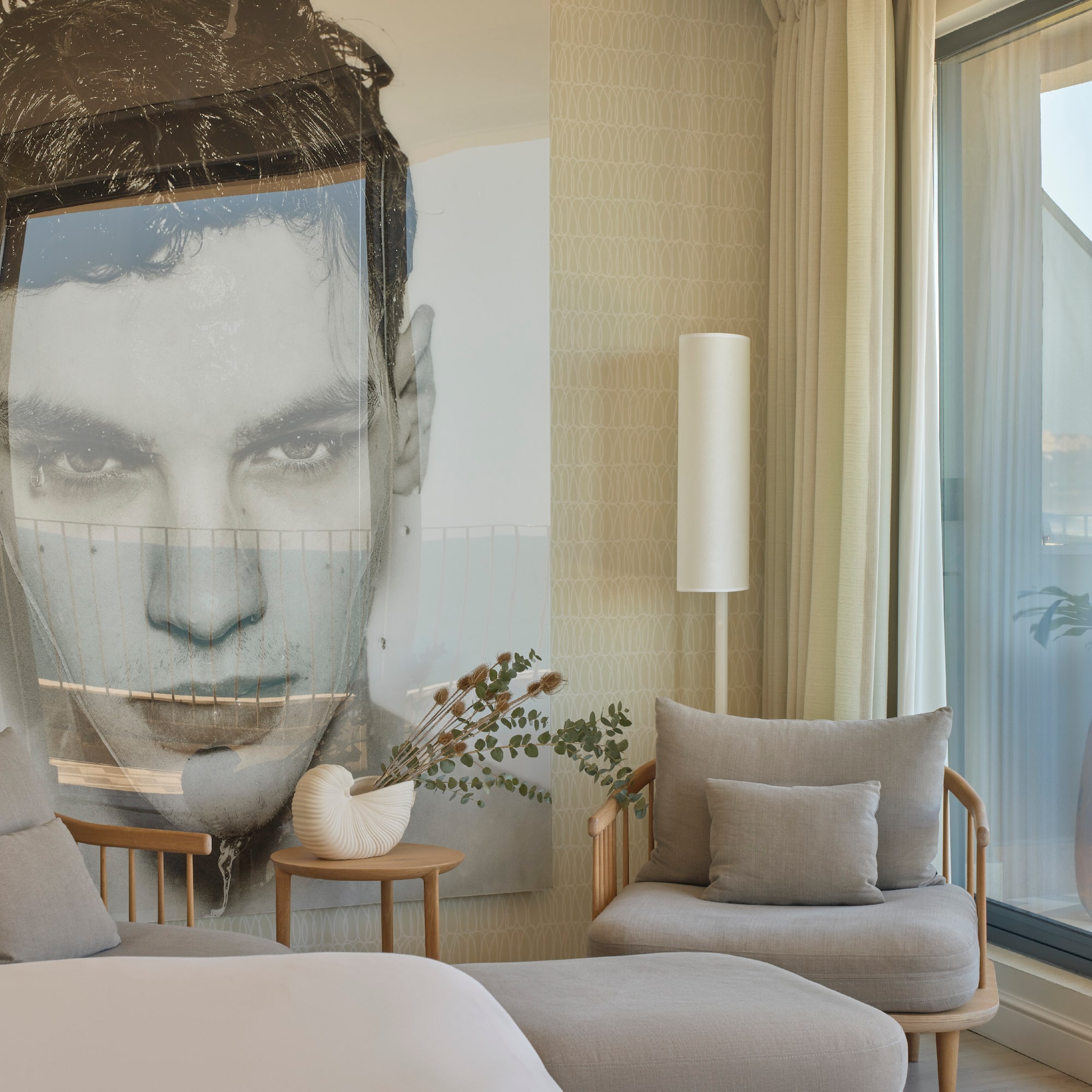 a bedroom with a large poster of a man's face