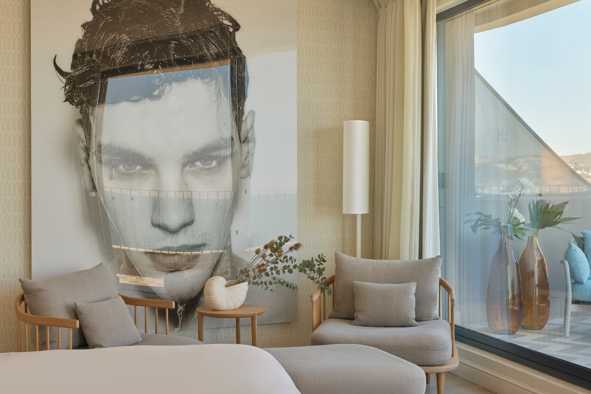a bedroom with a large poster of a man's face