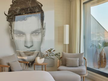 a bedroom with a large poster of a man's face