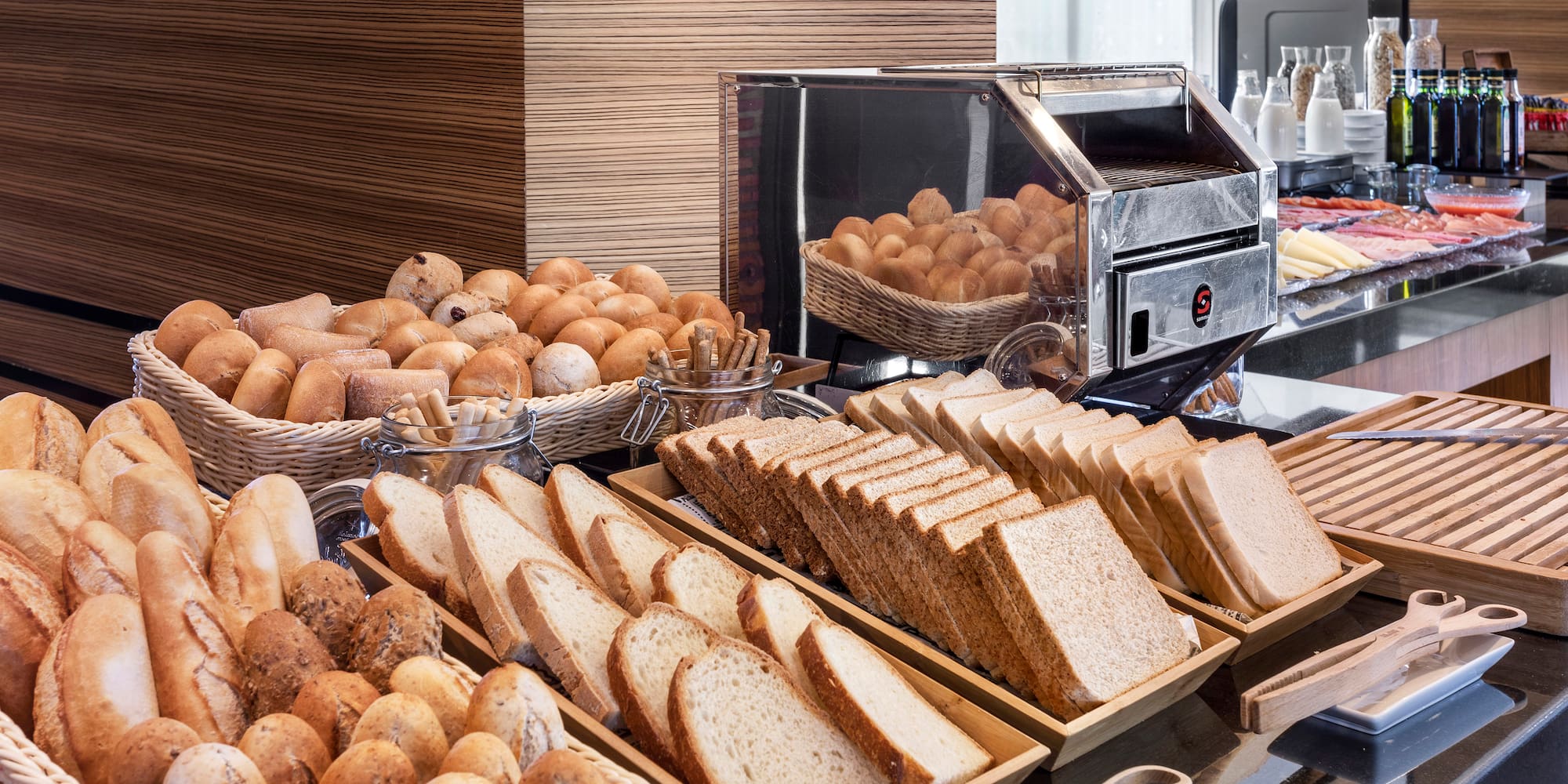 a buffet table with bread and rolls
