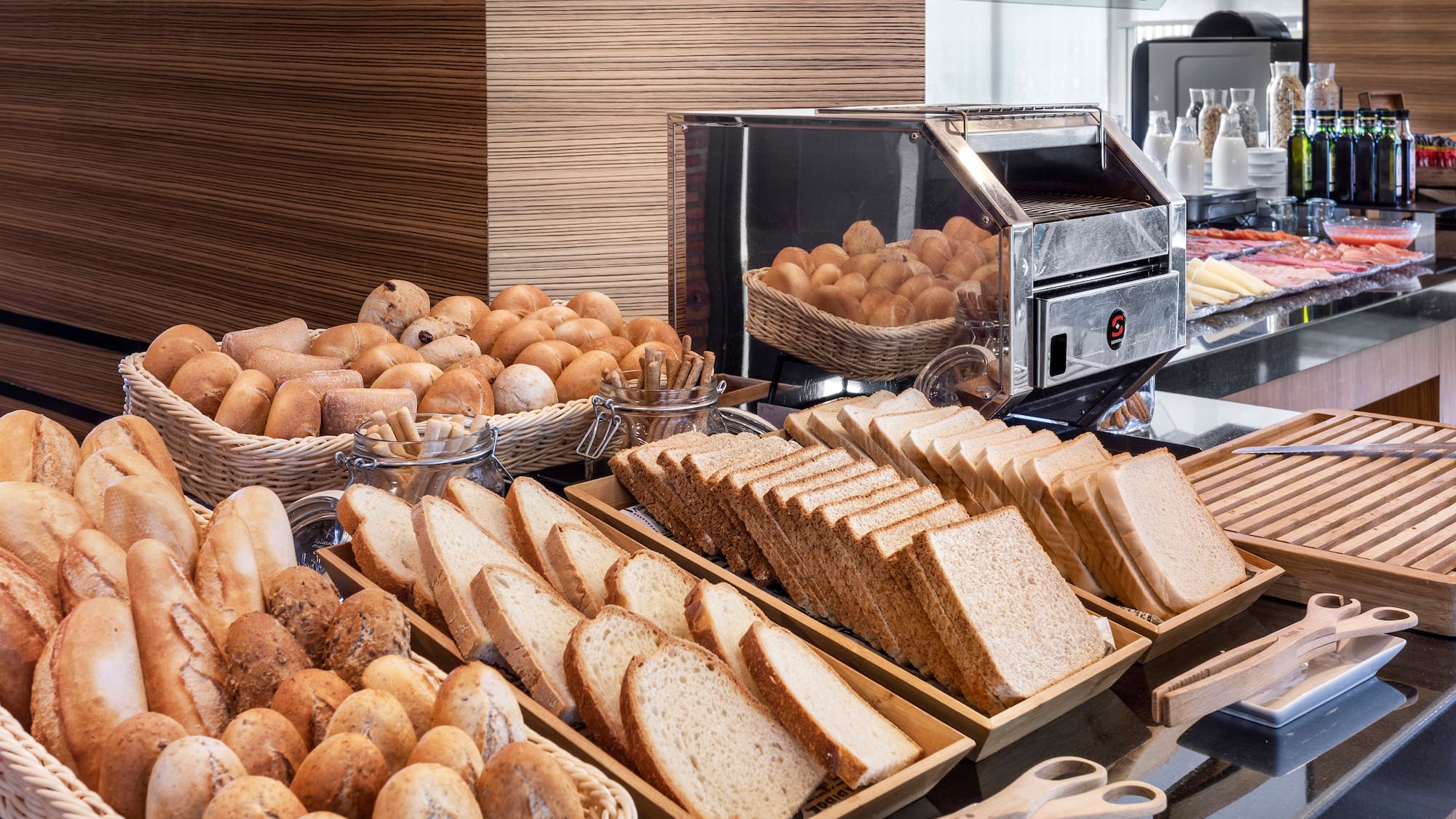 a buffet table with bread and rolls