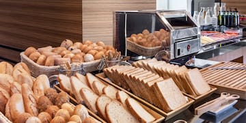 a buffet table with bread and rolls