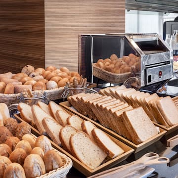 a buffet table with bread and rolls