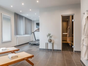 a room with a gym and a towel on the floor