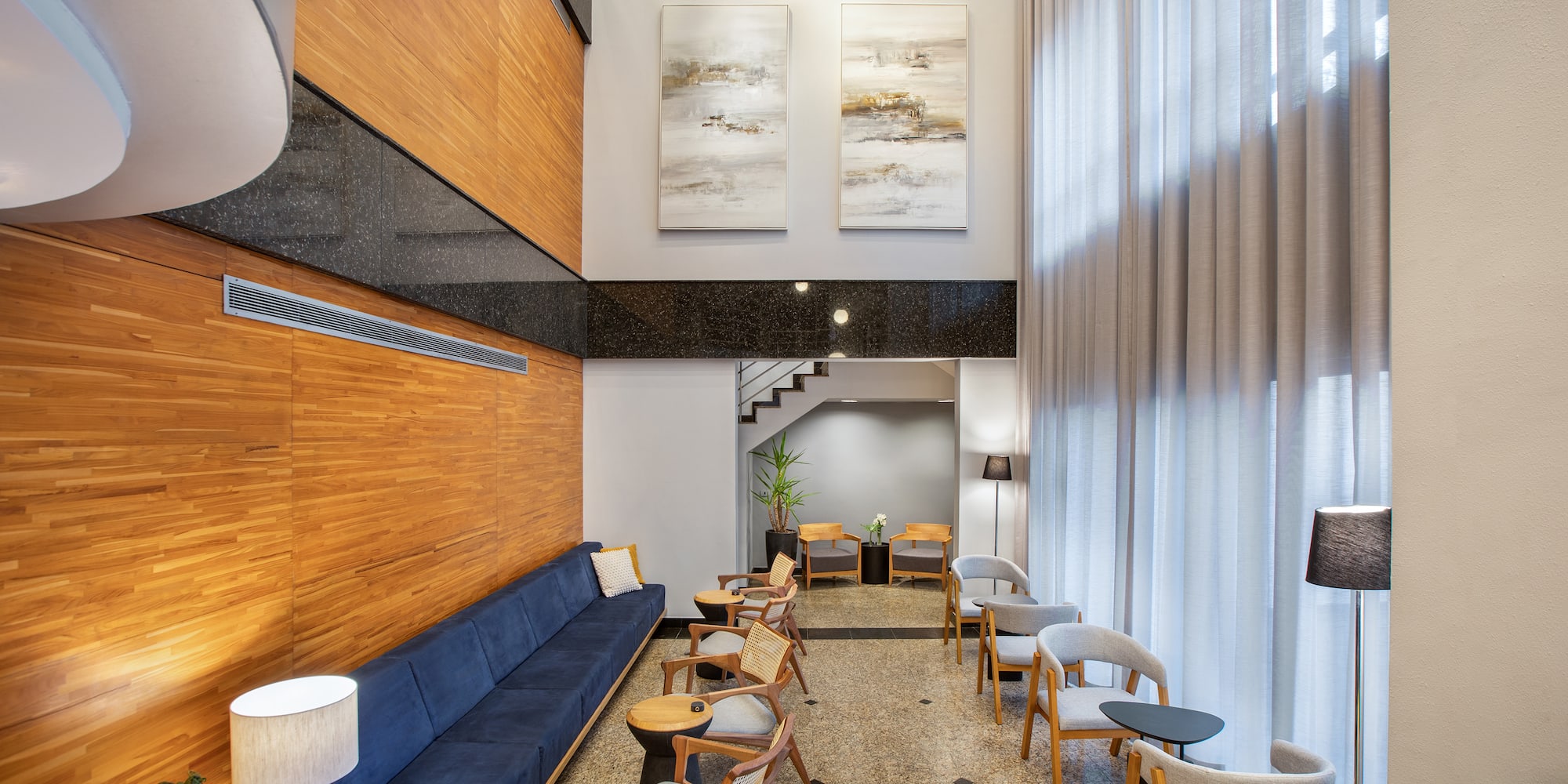 a room with a blue couch and chairs