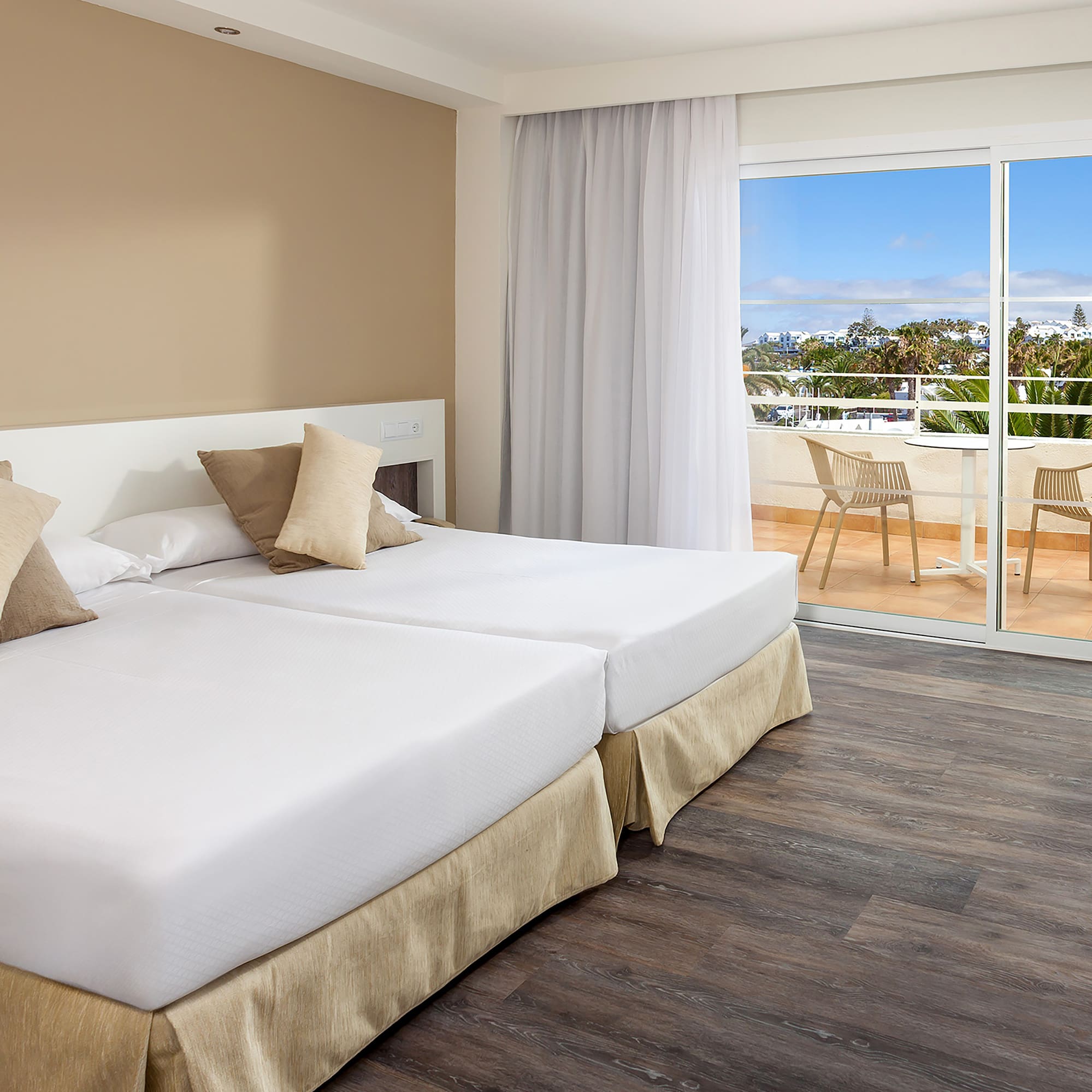 a room with two beds and a glass door