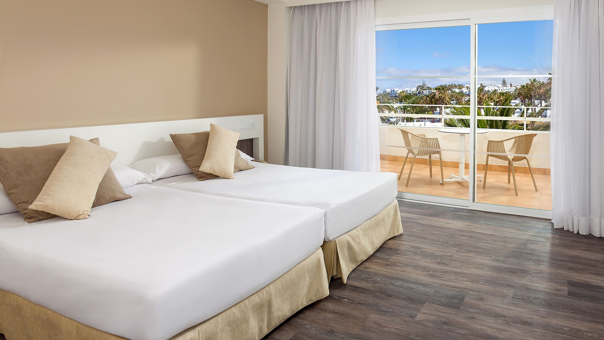 a room with two beds and a glass door