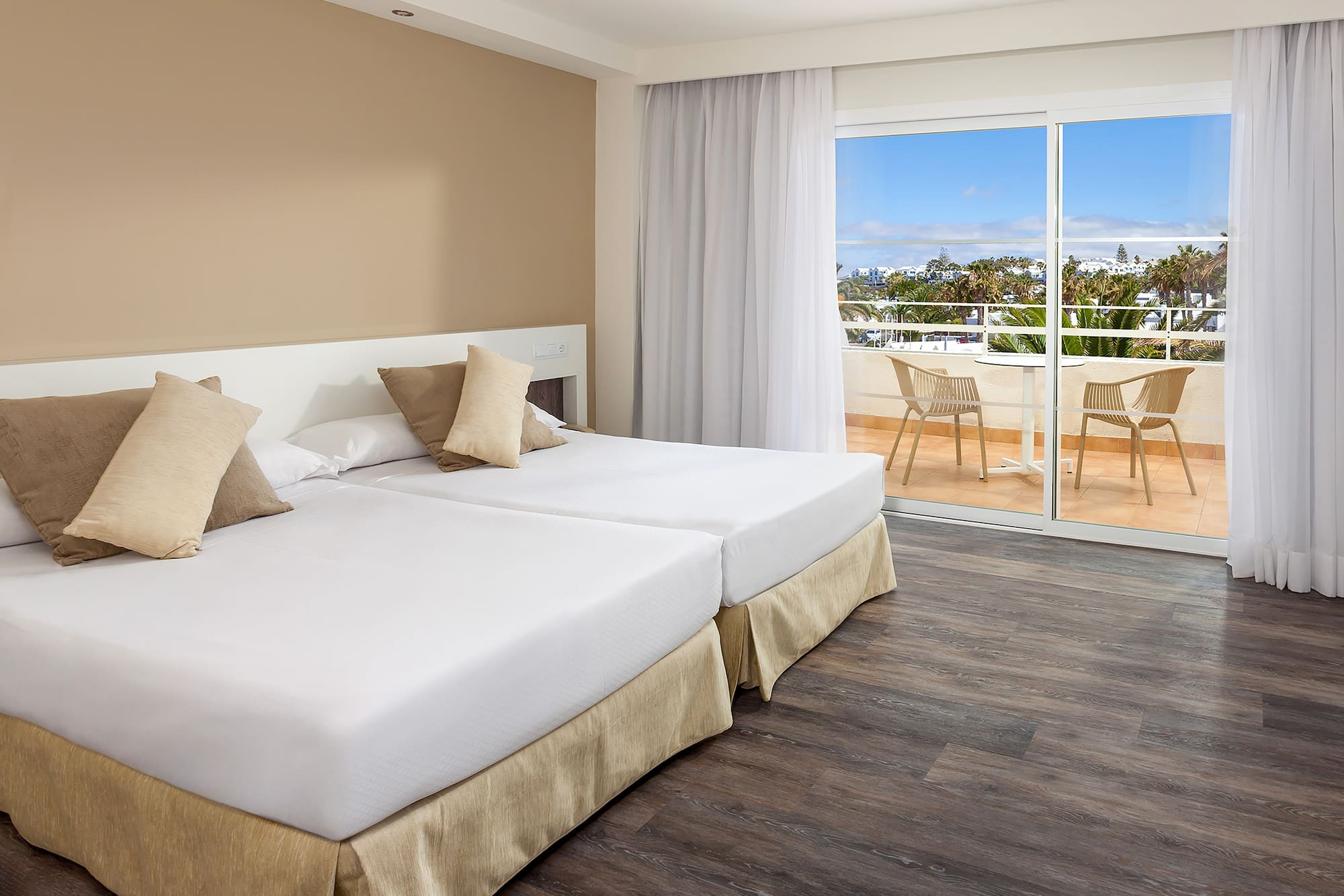 a room with two beds and a glass door