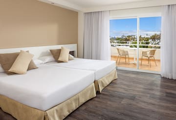 a room with two beds and a glass door