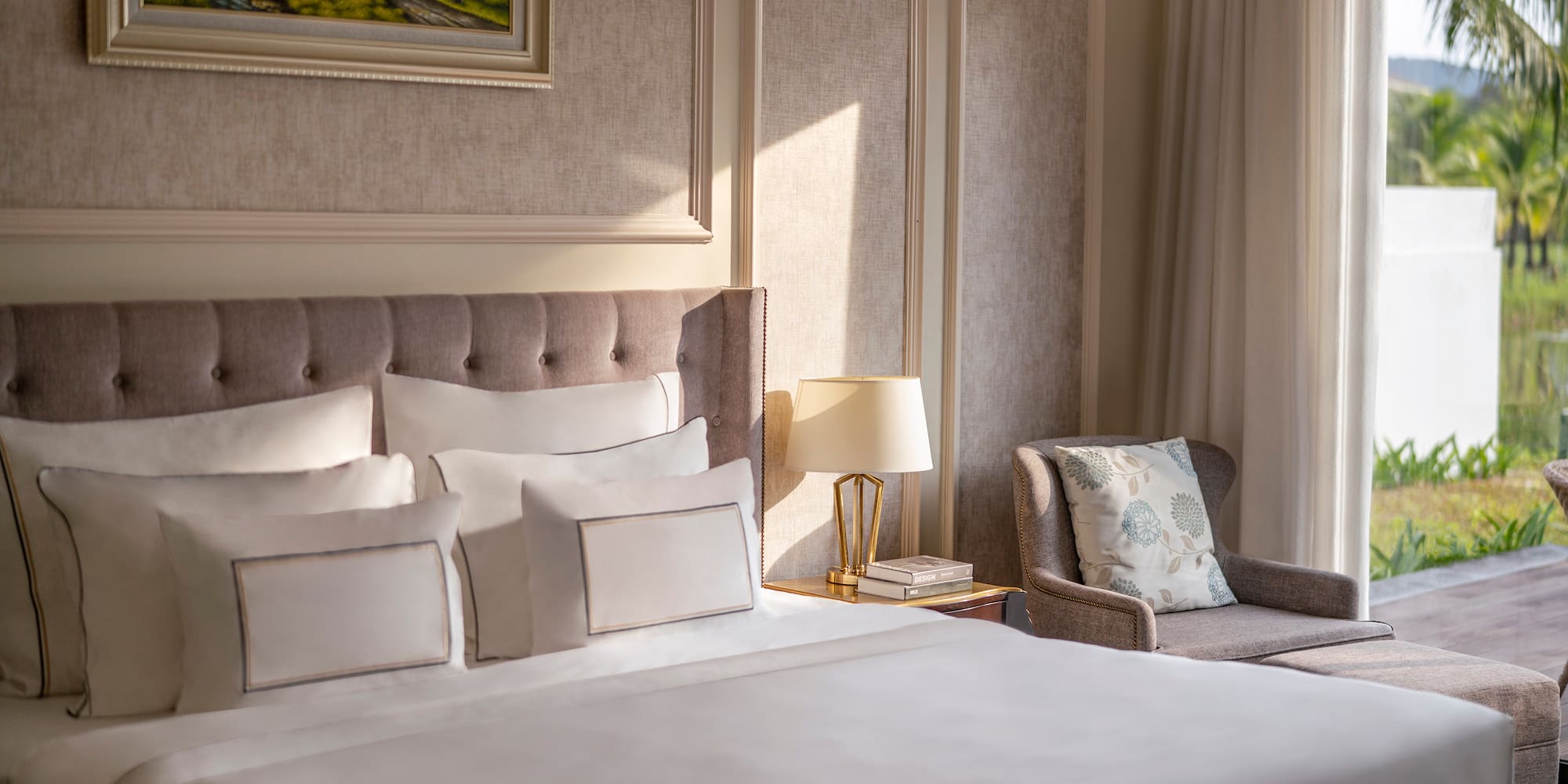 a bed with pillows and a chair in a room