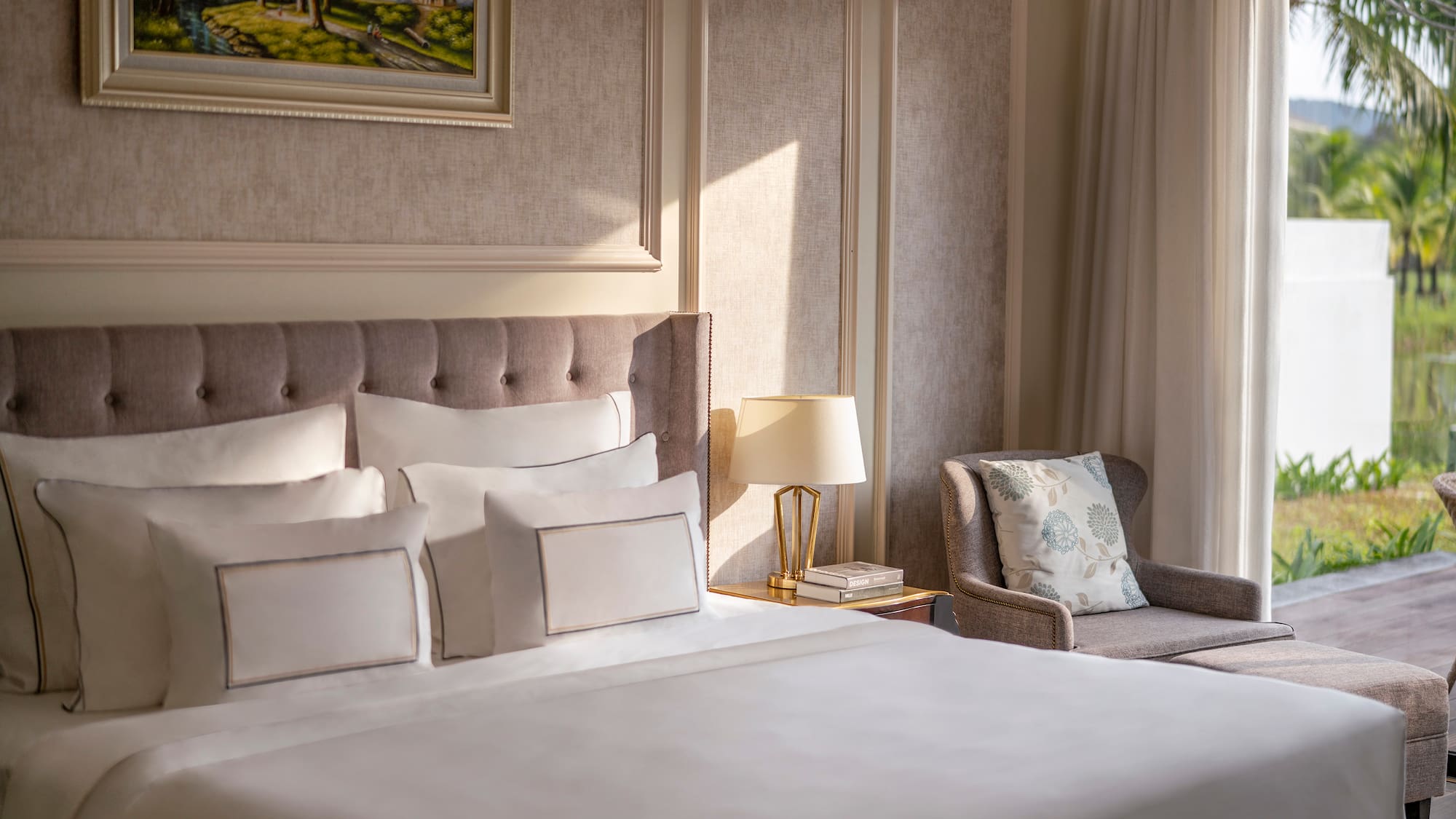 a bed with pillows and a chair in a room