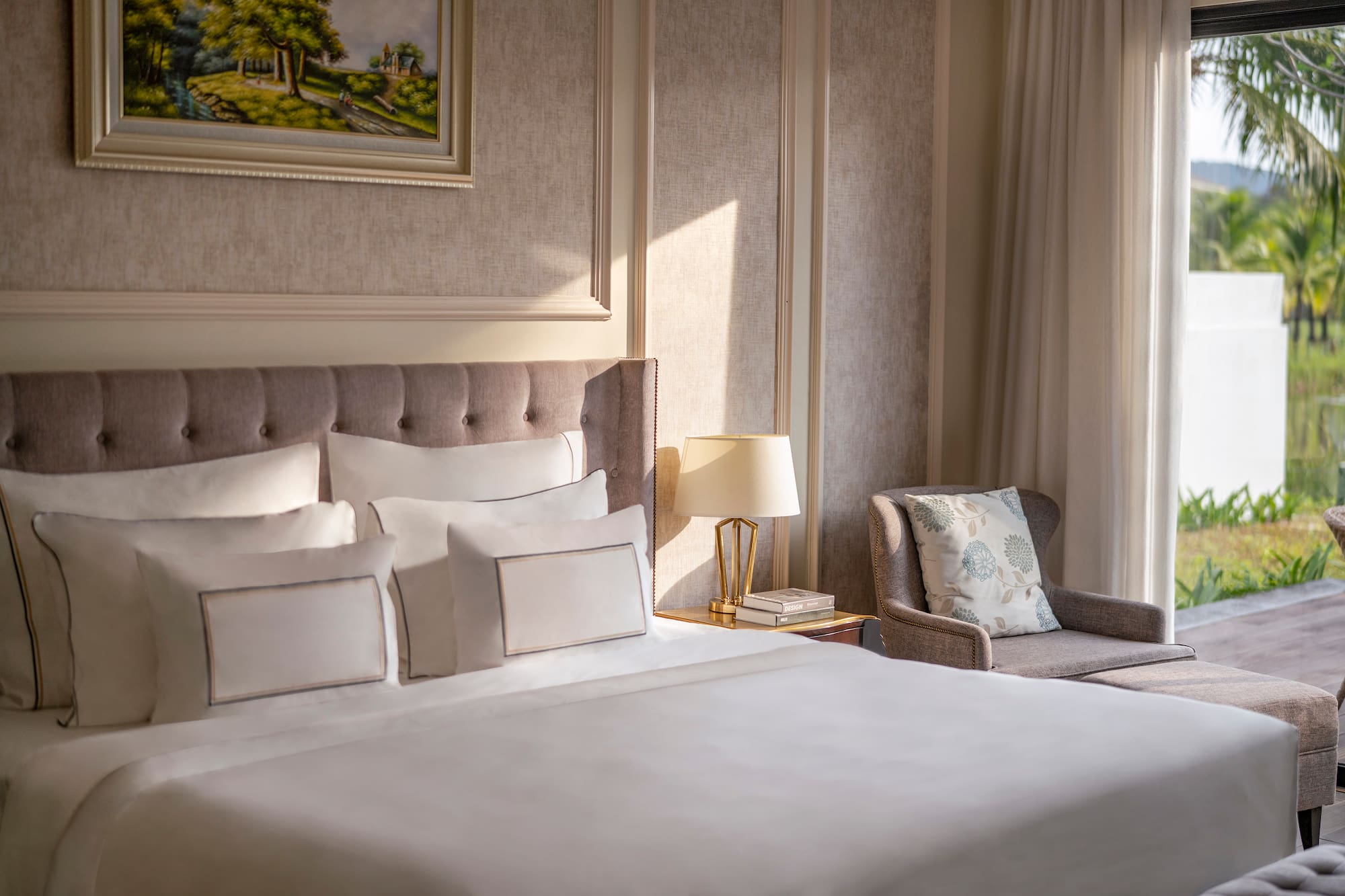 a bed with pillows and a chair in a room