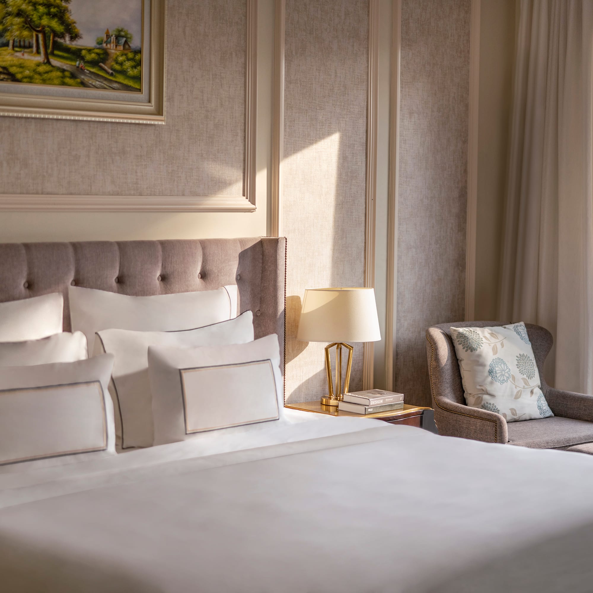 a bed with pillows and a chair in a room