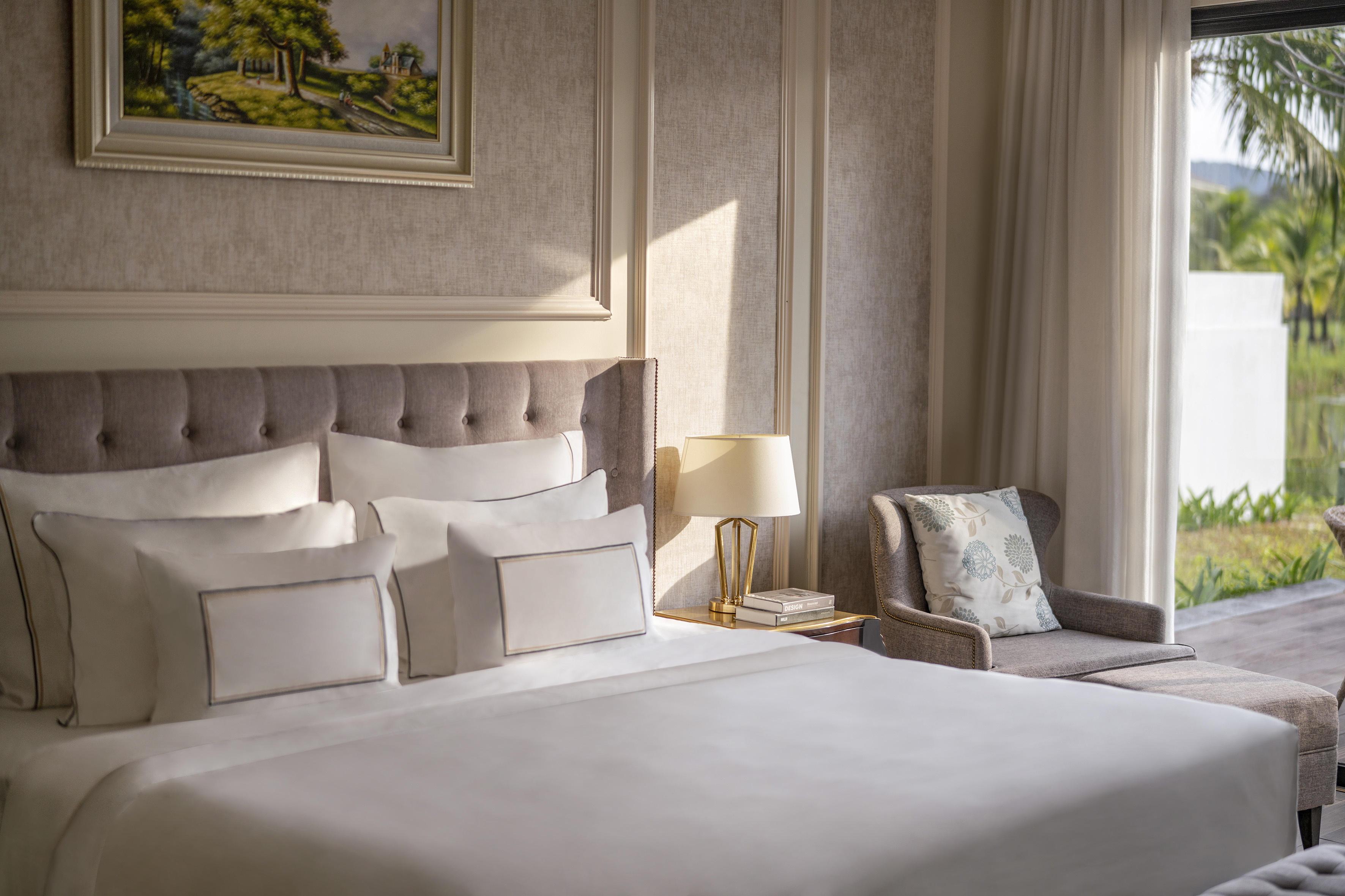 a bed with pillows and a chair in a room