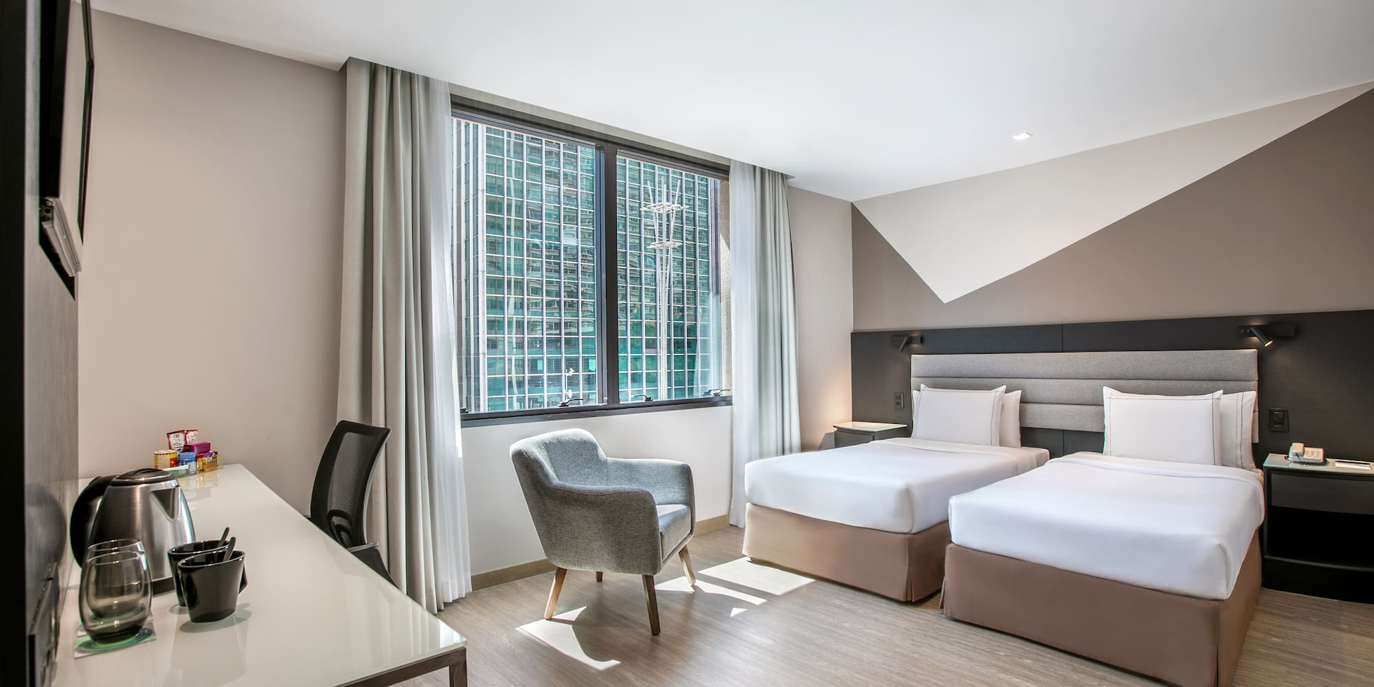 a room with two beds and a desk