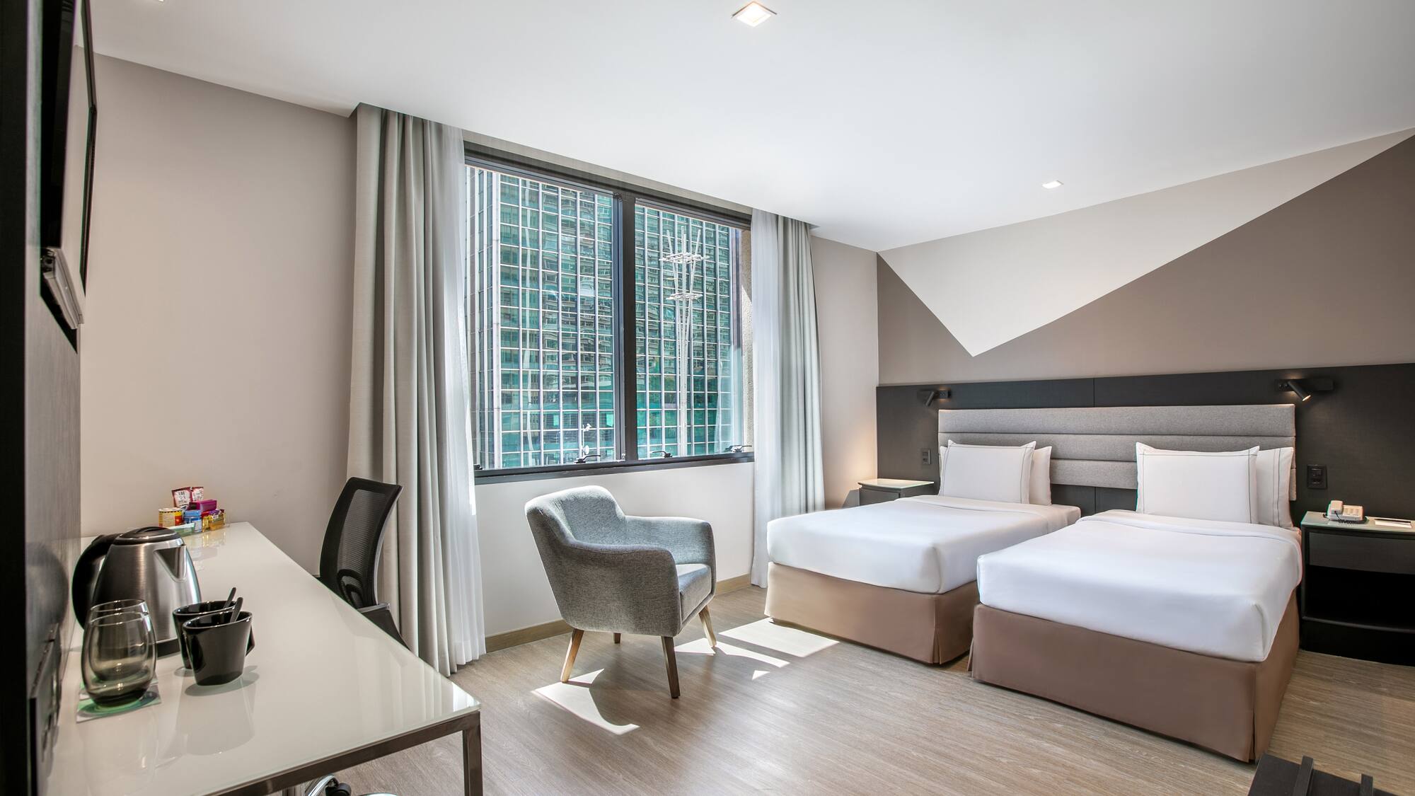 a room with two beds and a desk