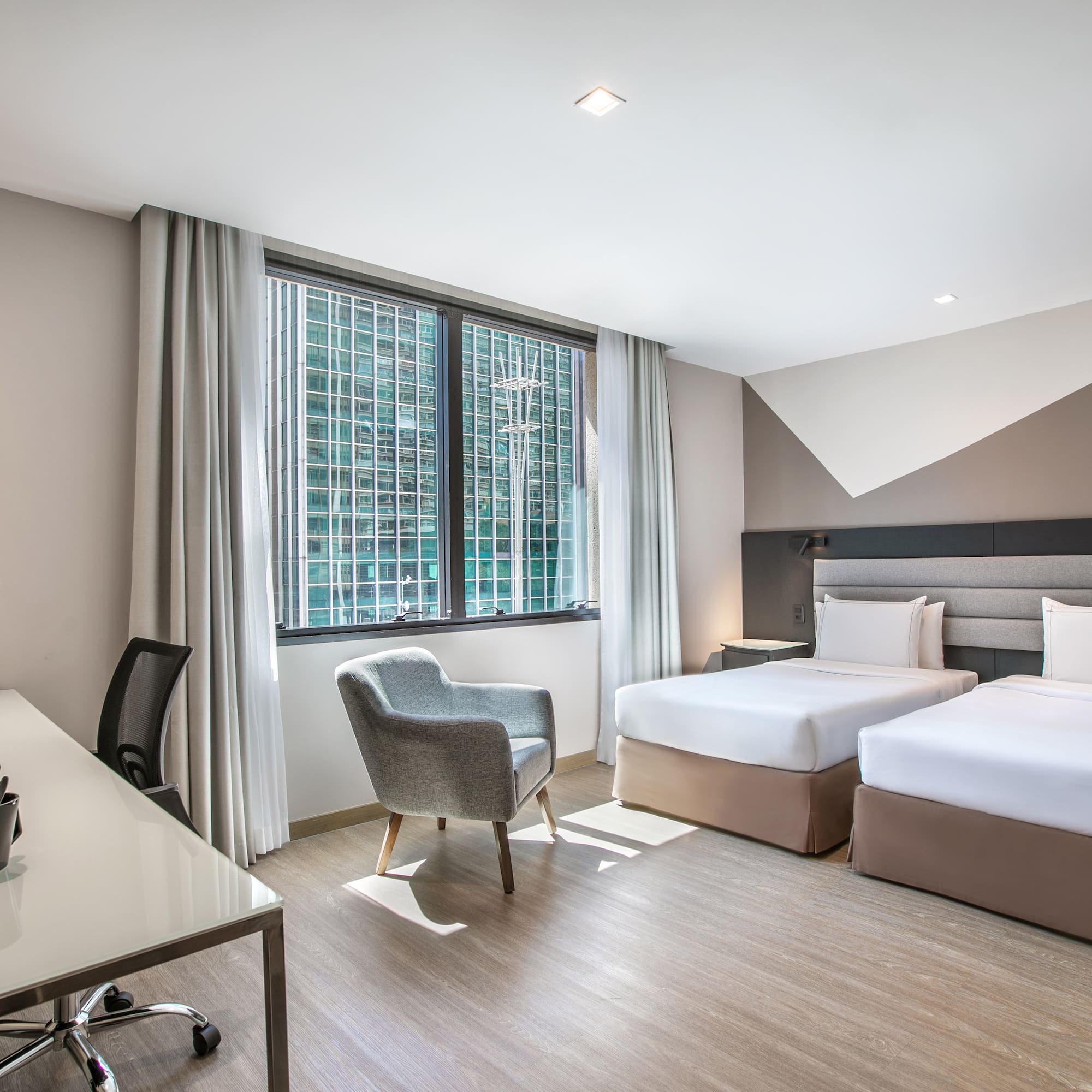 a room with two beds and a desk